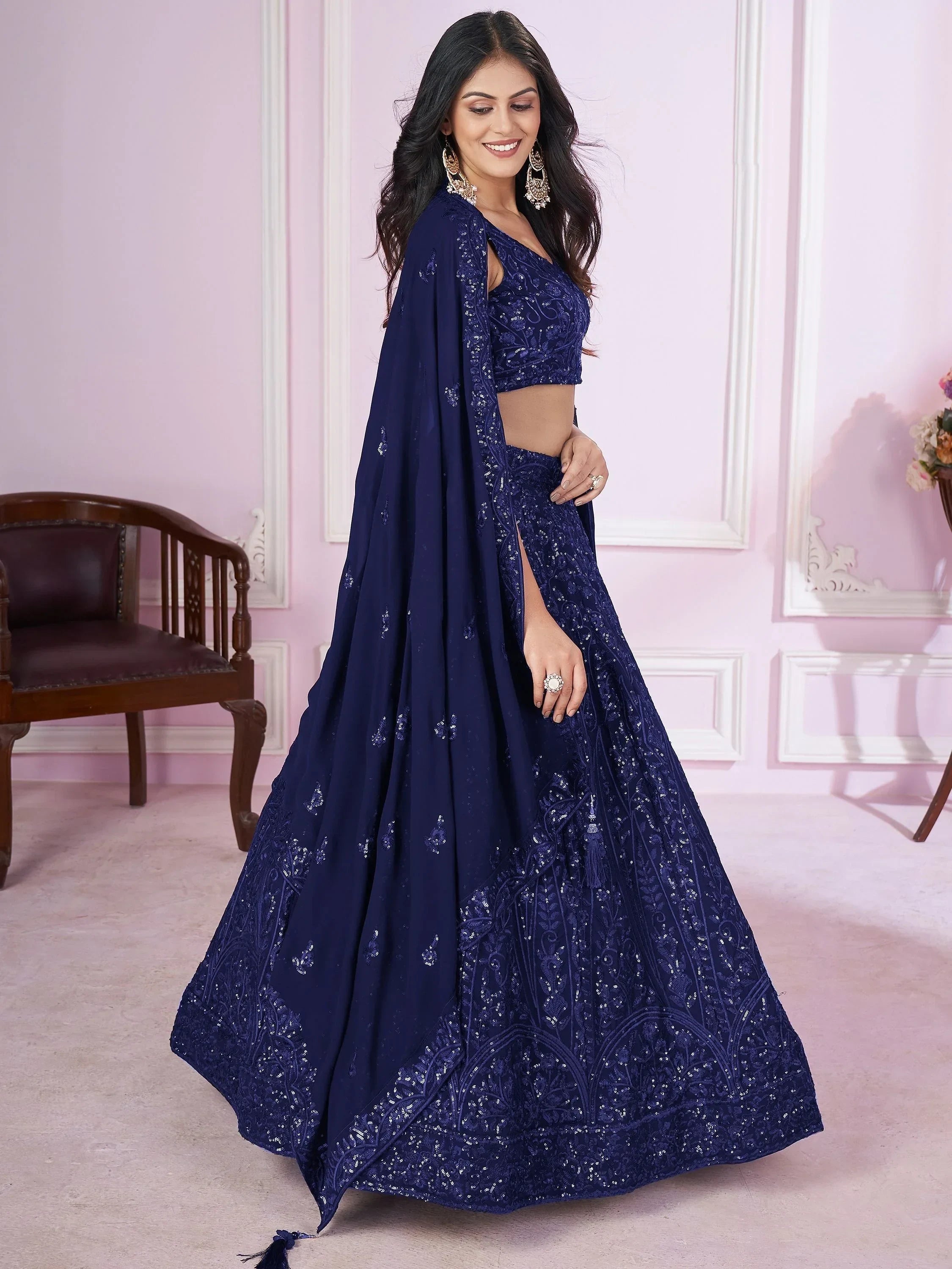 Navy blue designer lehenga choli with intricate embroidery and sequins, perfect for weddings and parties