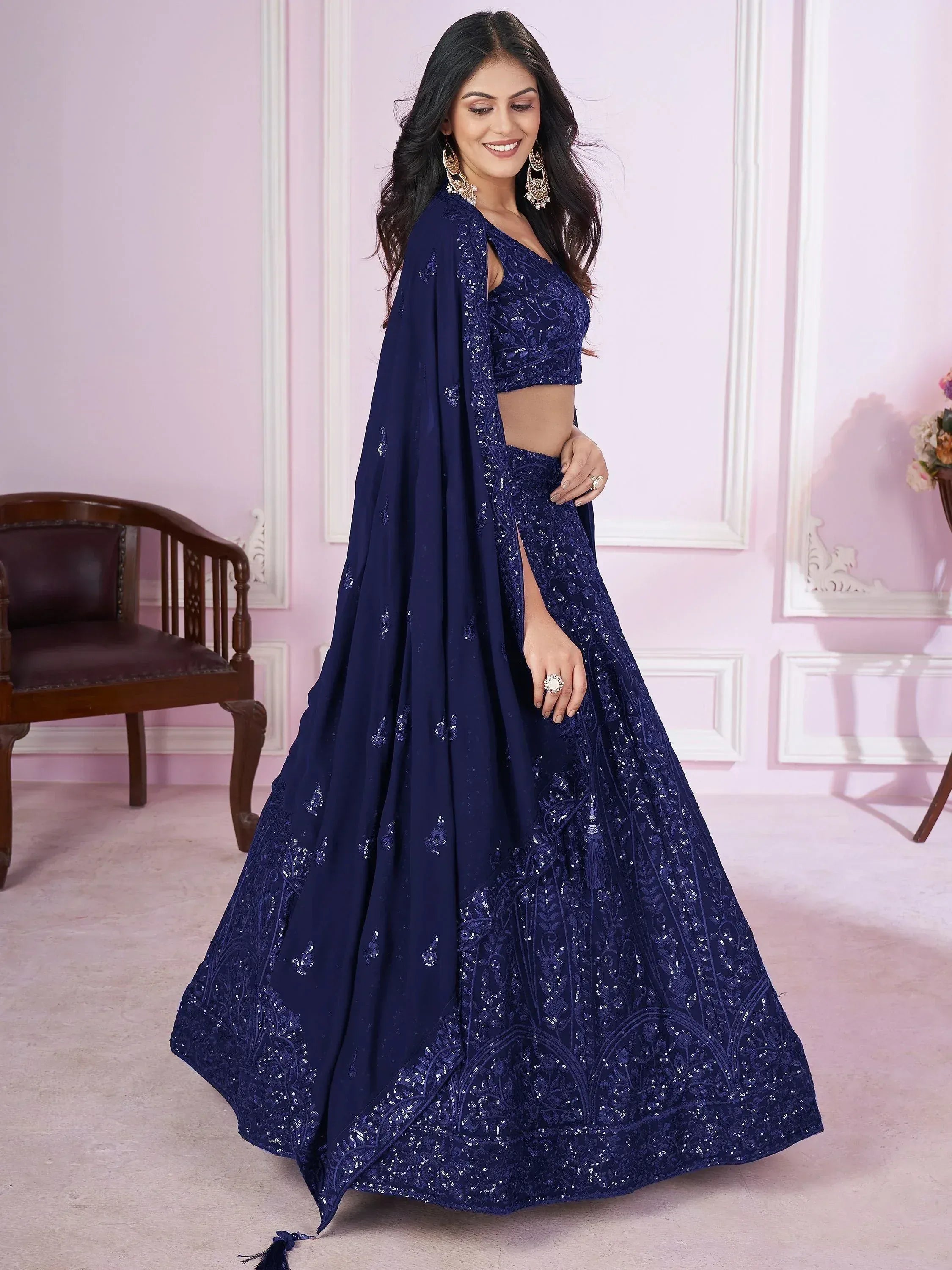 Navy blue designer lehenga choli with intricate embroidery and sequins, perfect for weddings and parties
