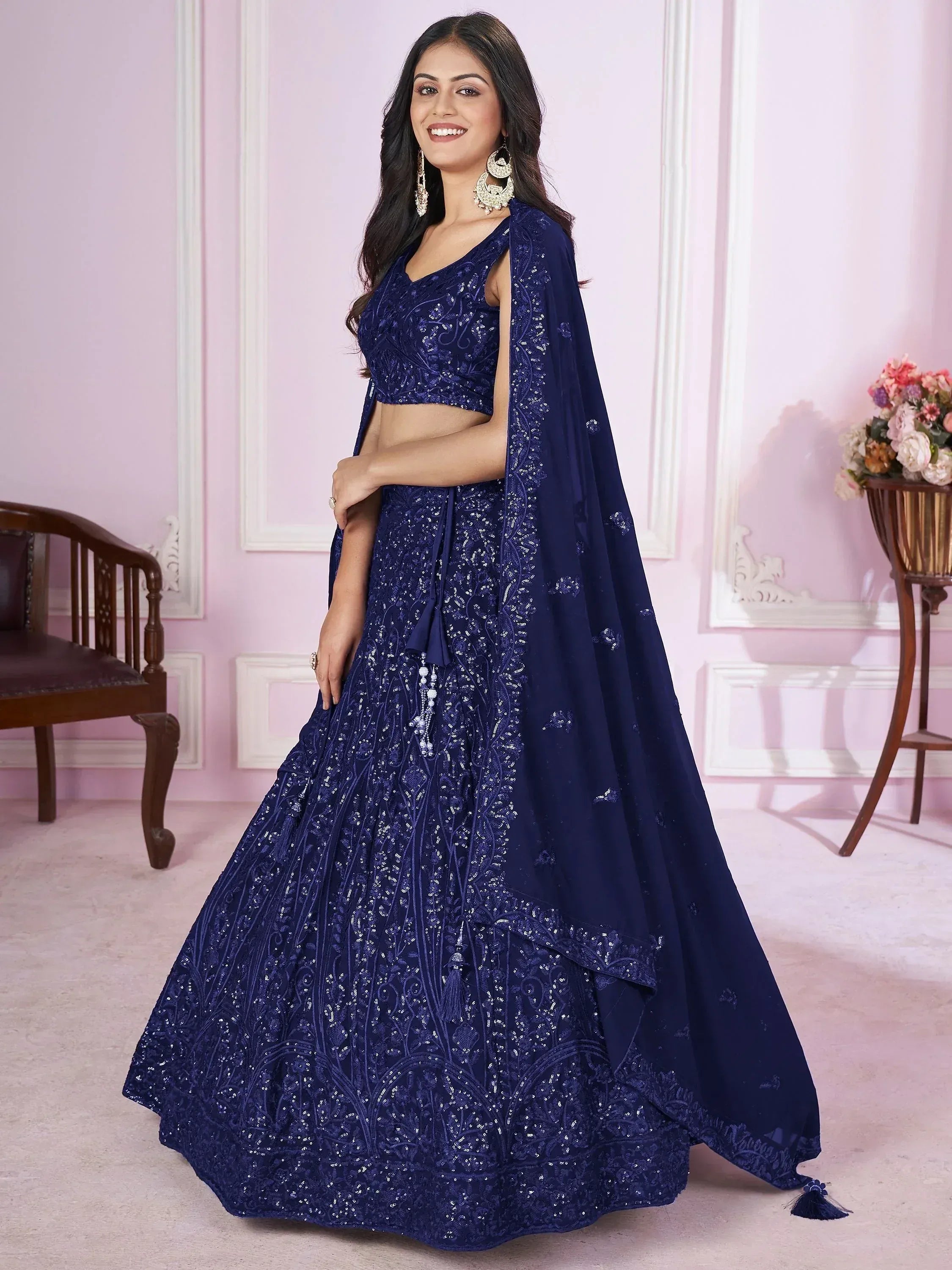 Navy blue designer lehenga choli with intricate embroidery and sequins, perfect for Indian ethnic wear occasions