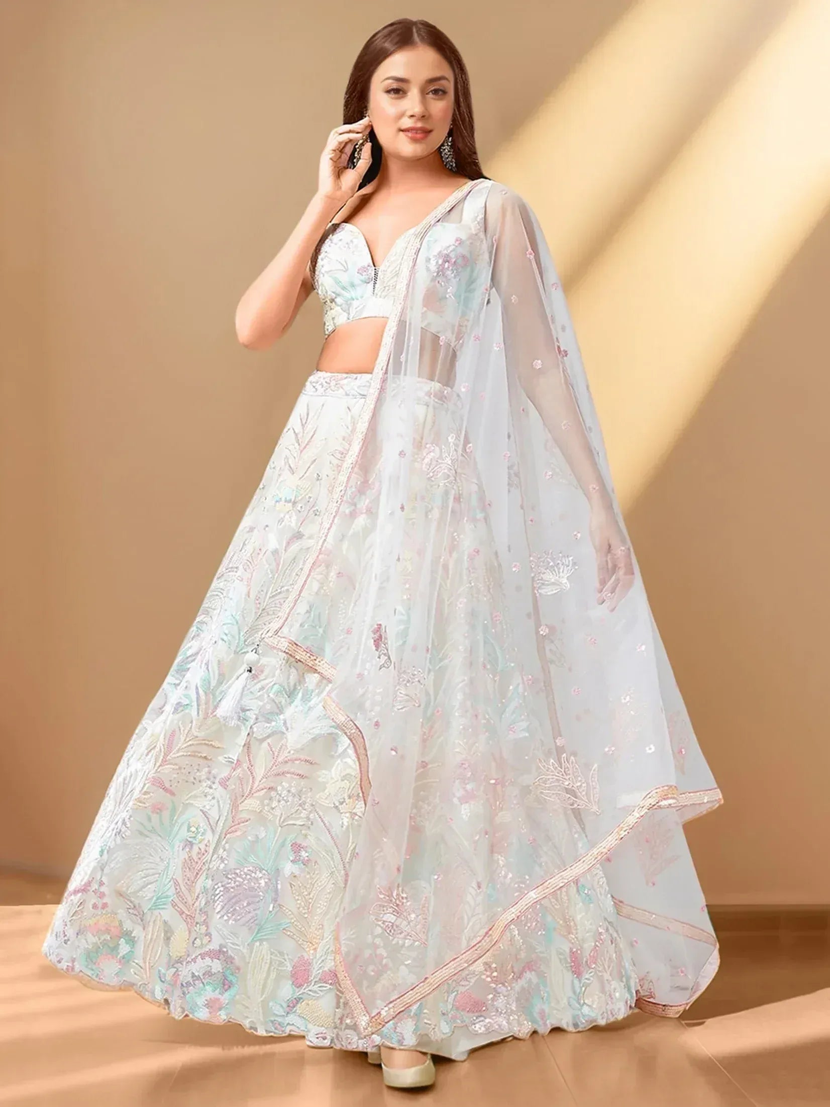 Elegant pastel lehenga choli with floral embroidery and sheer dupatta for Indian ethnic wear