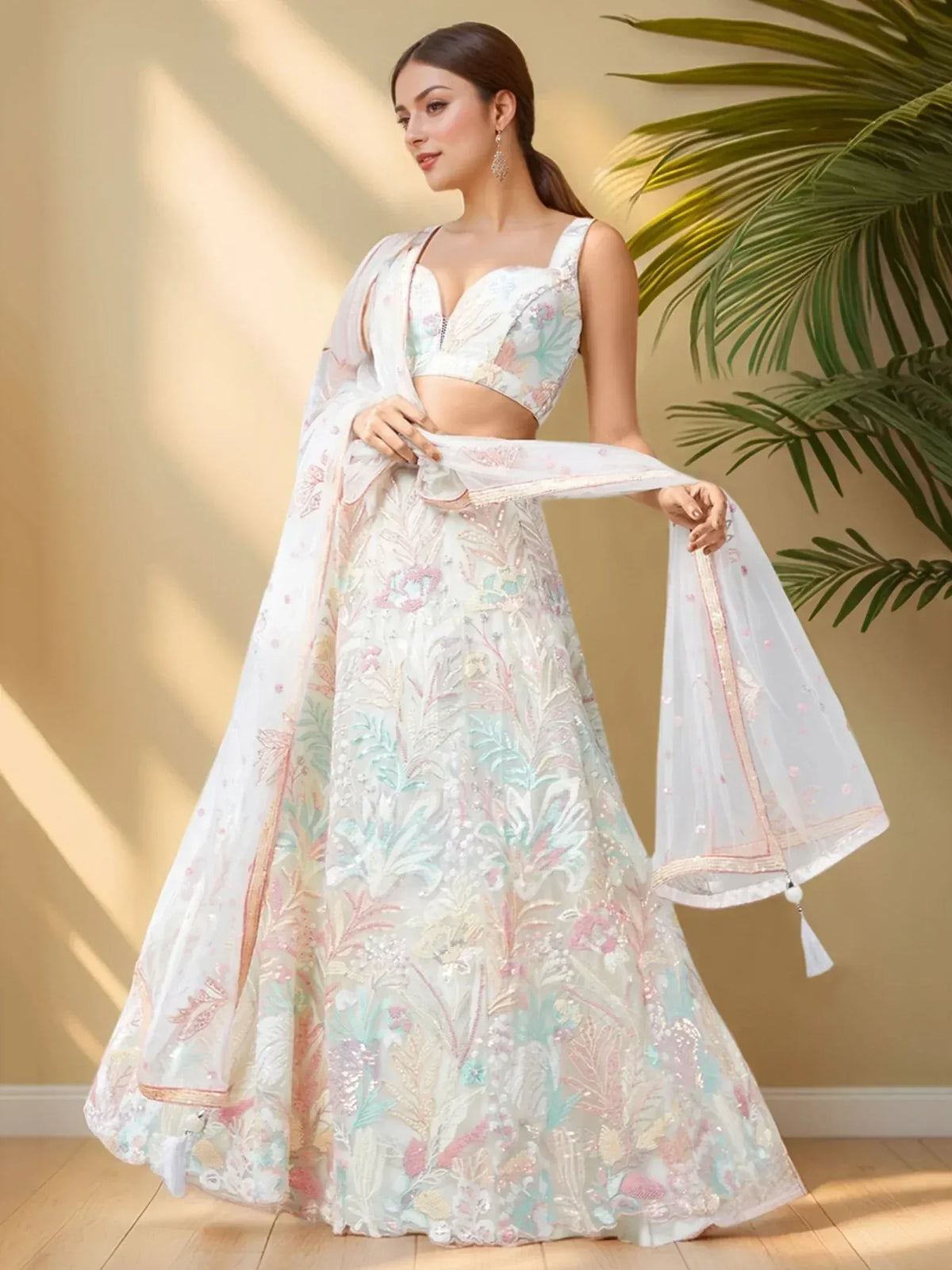Elegant white lehenga choli with pastel floral embroidery and sheer dupatta, perfect for Indian ethnic wear occasions.