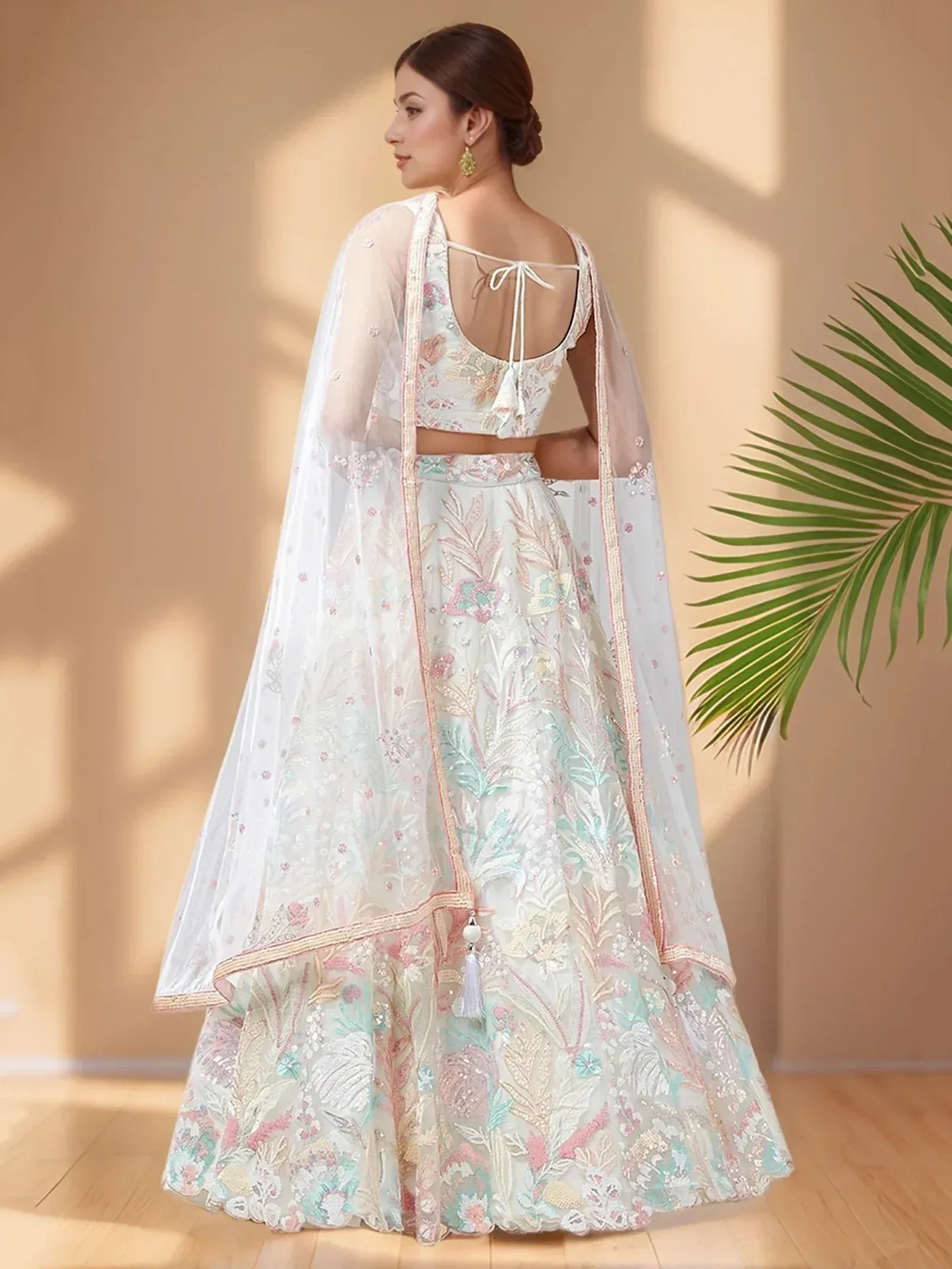 White floral embroidered lehenga choli with sheer dupatta, perfect for Indian weddings and festive occasions.