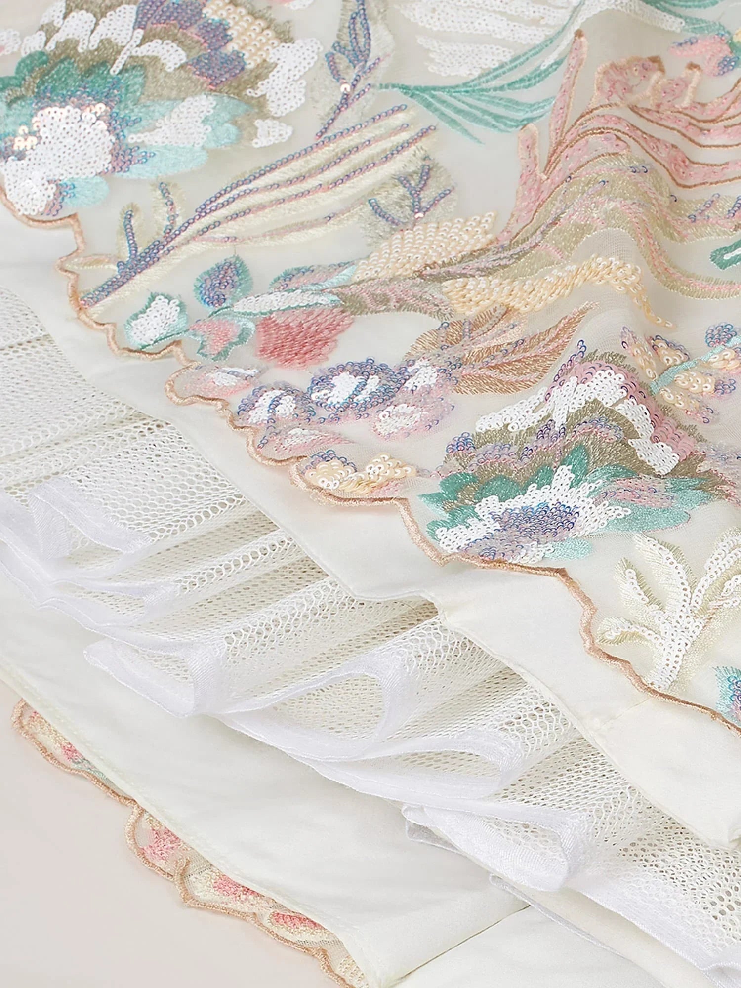 Elegant floral embroidered lehenga with pastel sequins and lace detailing, perfect for Indian ethnic wear.