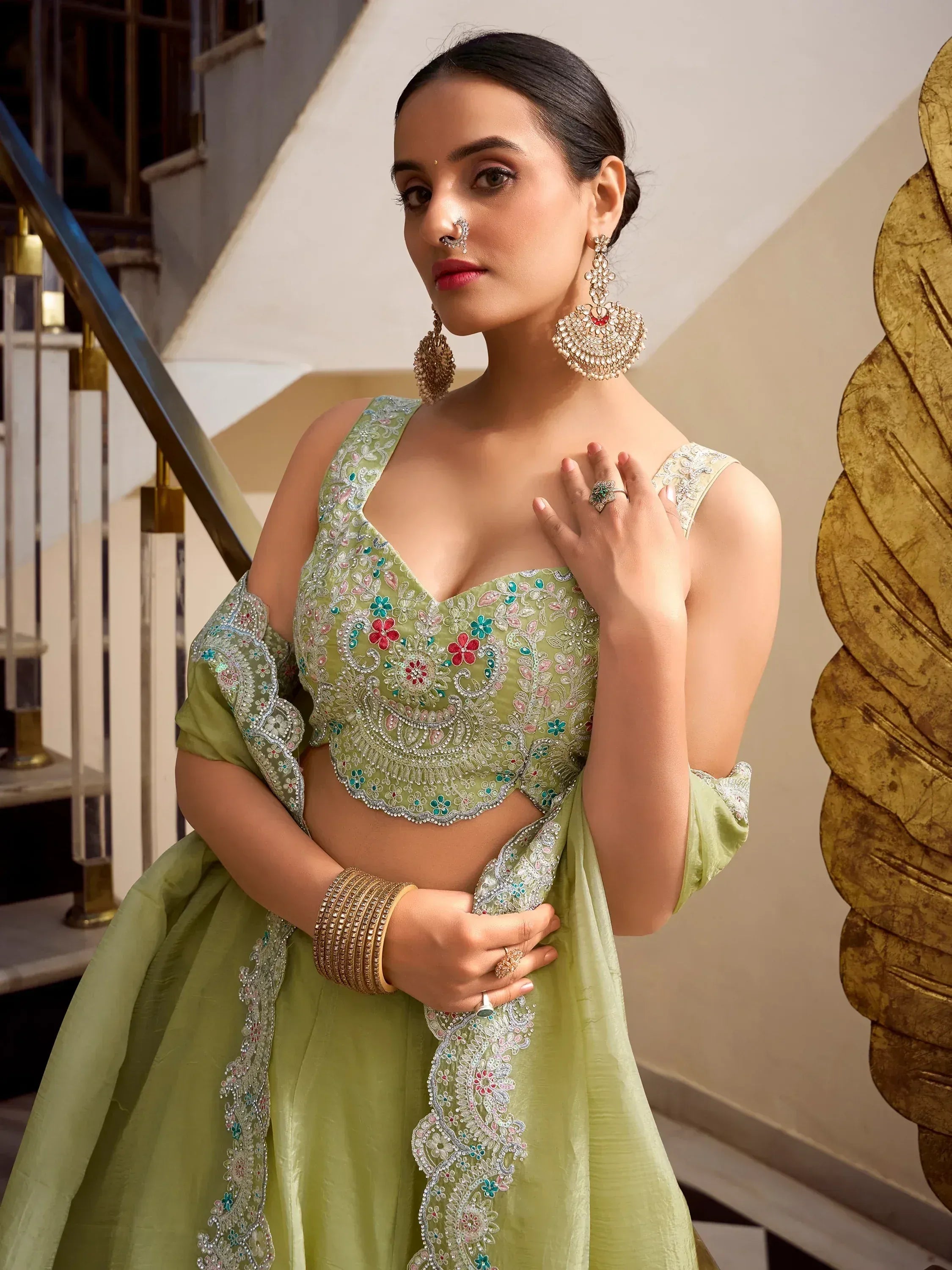 Green embroidered lehenga choli with floral motifs, perfect for Indian ethnic wear occasions.