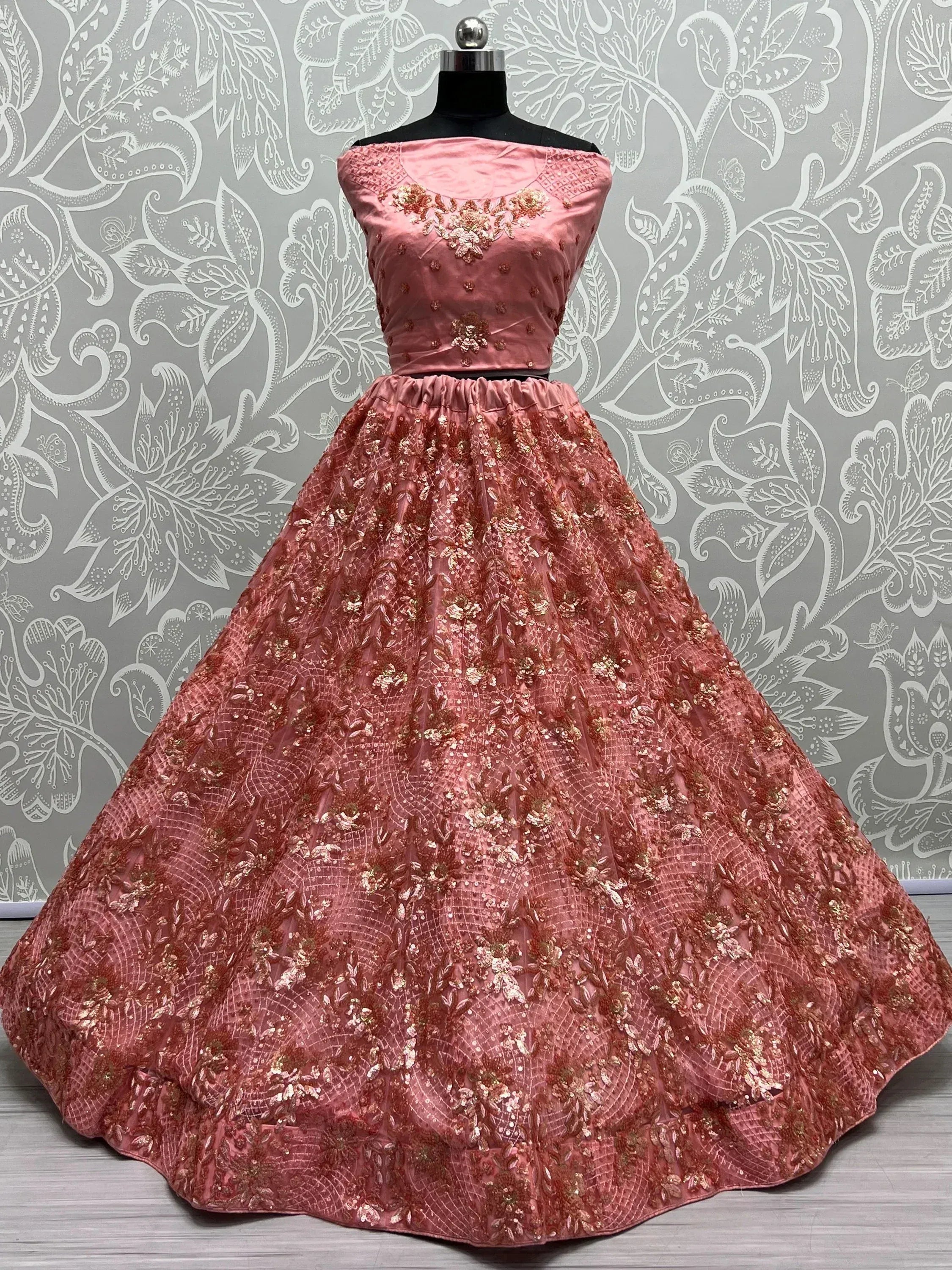 Pink embroidered ethnic gown with floral embellishments, perfect for Indian weddings and parties