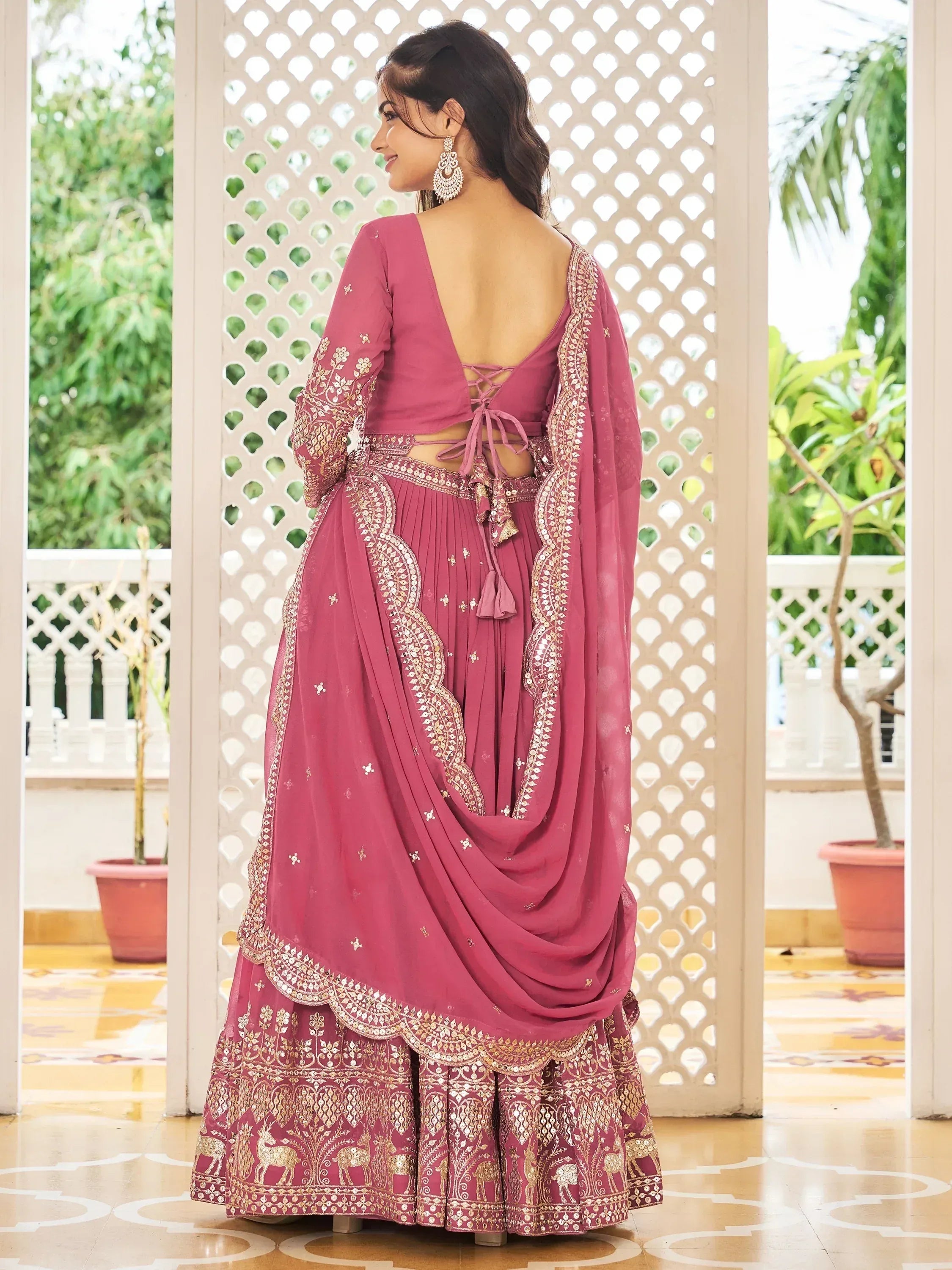 Pink embroidered lehenga choli with gold detailing, back view, ethnic Indian wear