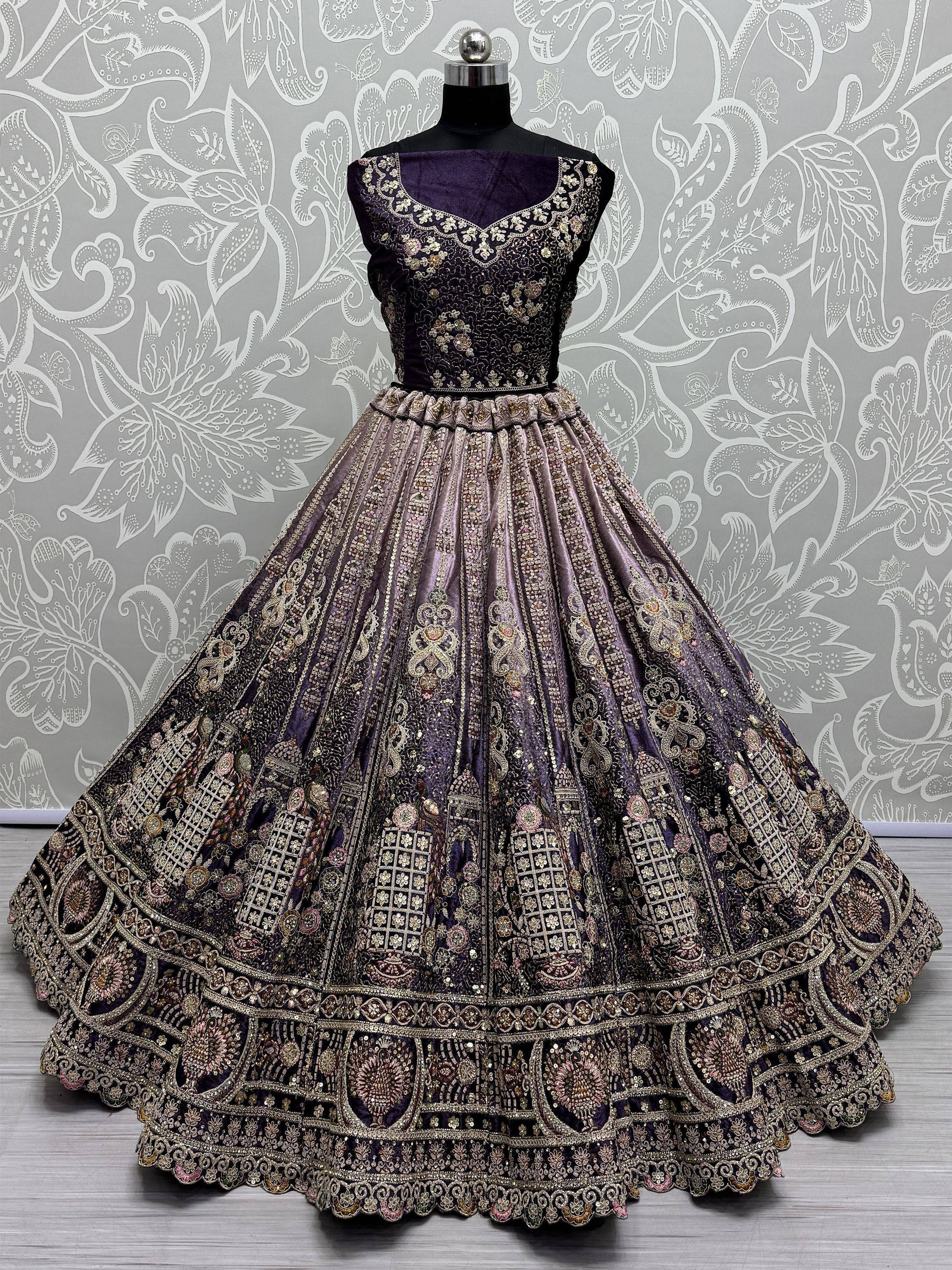 Purple designer lehenga choli with heavy gold embroidery and floral patterns, displayed on mannequin