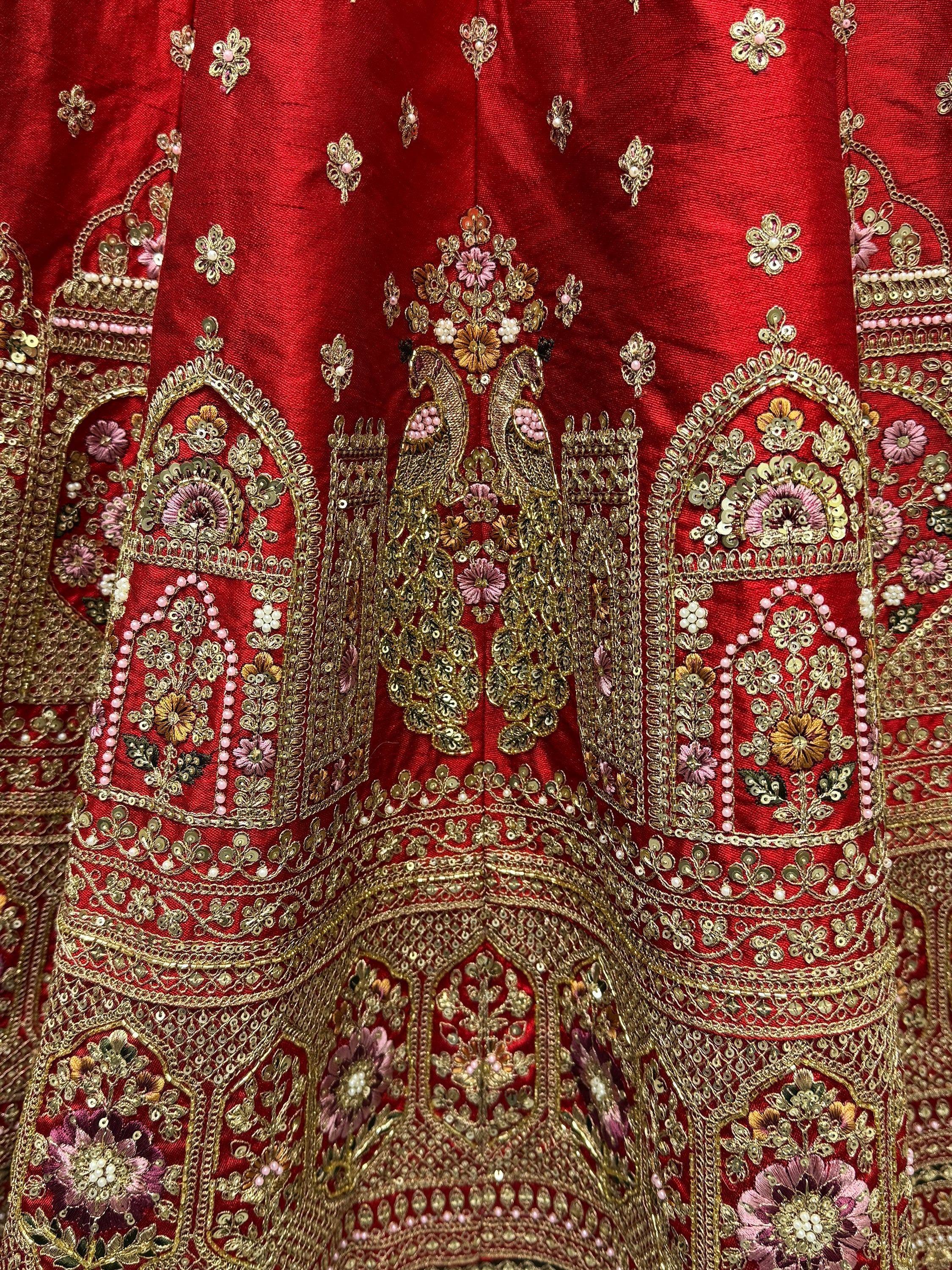 Red ethnic lehenga with gold peacock embroidery and floral sequin work for Indian weddings