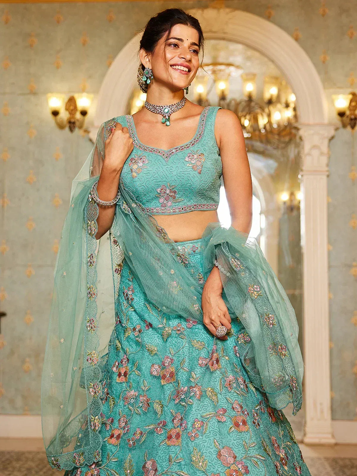 Turquoise floral embroidered lehenga choli with net dupatta, perfect for Indian weddings and festive occasions.