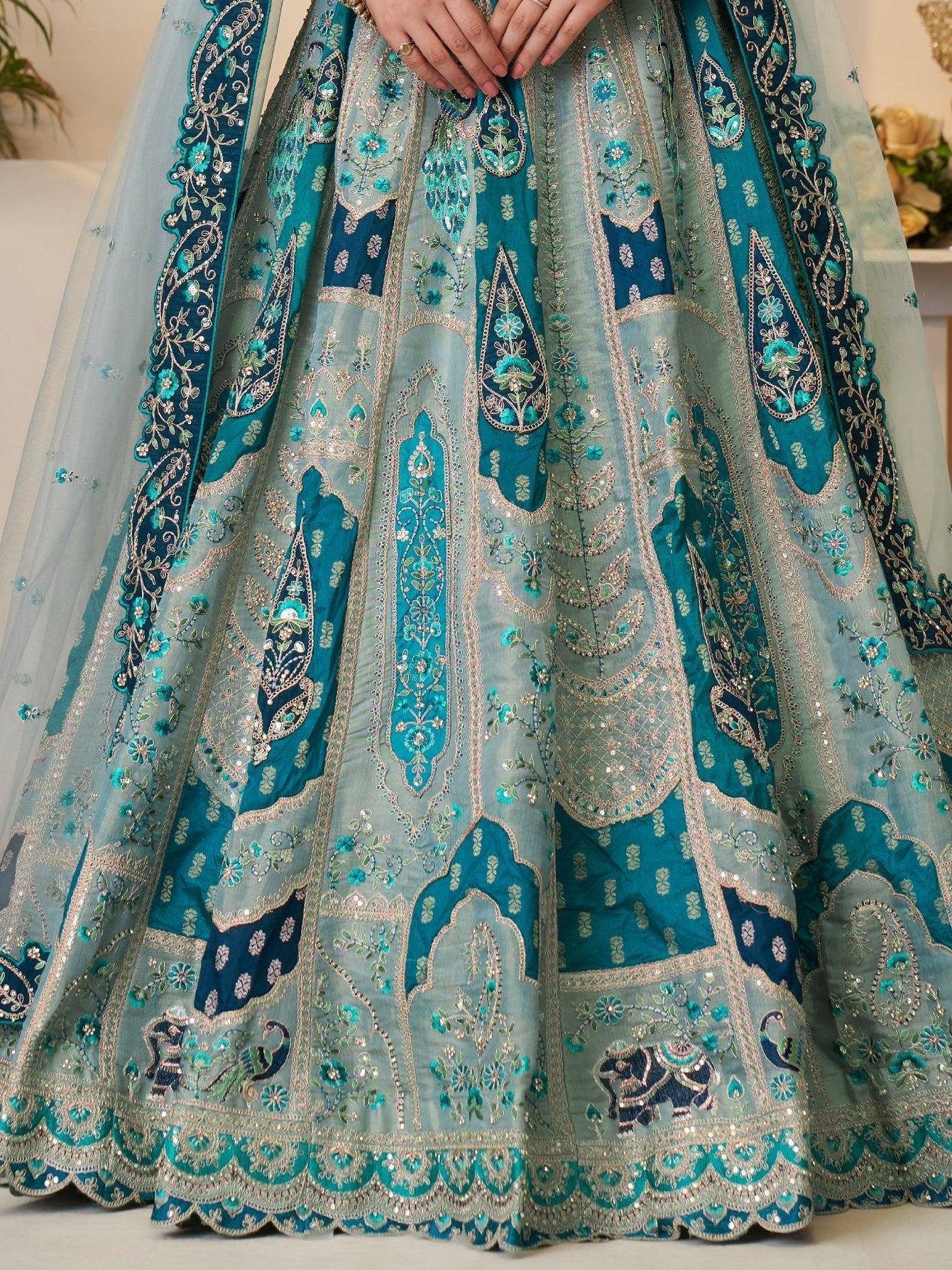 Teal and silver embroidered lehenga with floral and elephant motifs, perfect for Indian weddings and festive occasions.