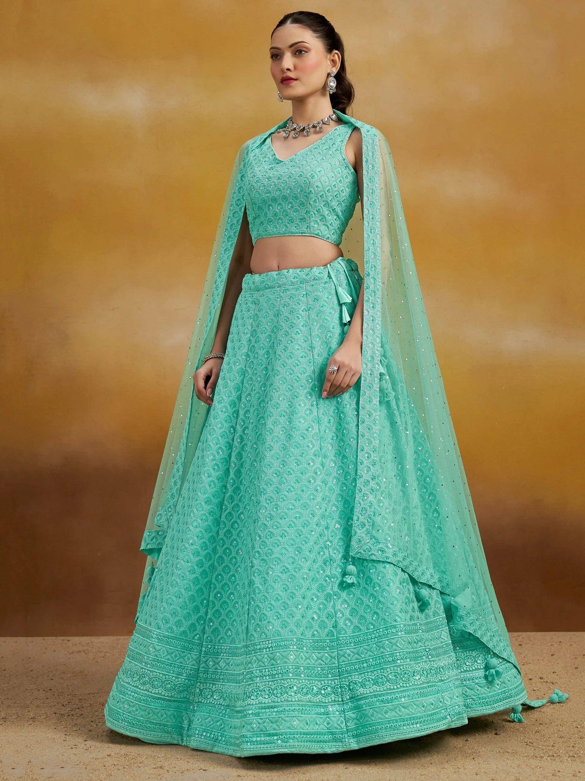 Mint green designer lehenga choli with sequin embroidery and sheer dupatta, perfect for Indian ethnic wear events
