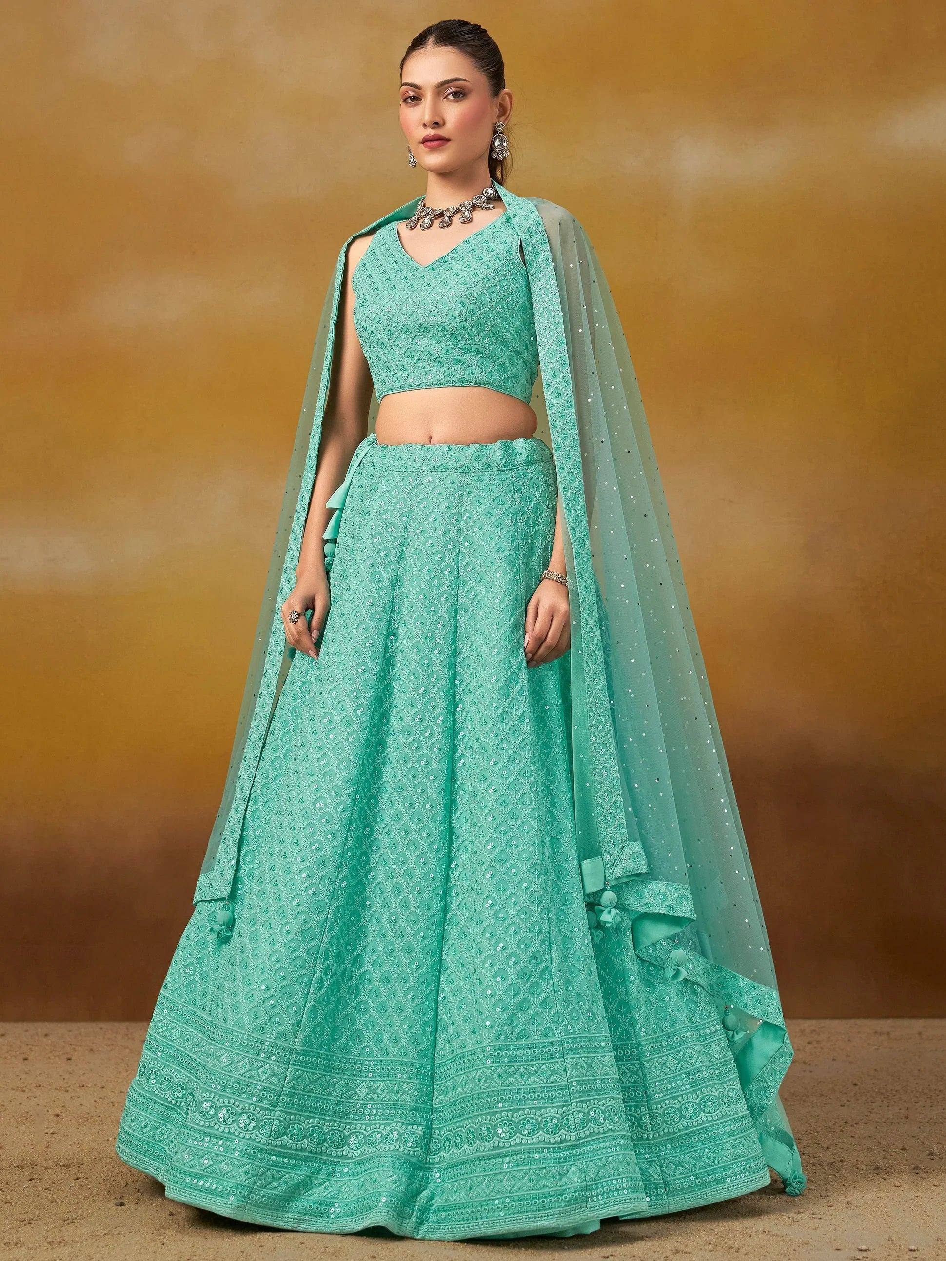 Mint green embroidered lehenga choli with sheer dupatta, perfect for Indian weddings and festive occasions.