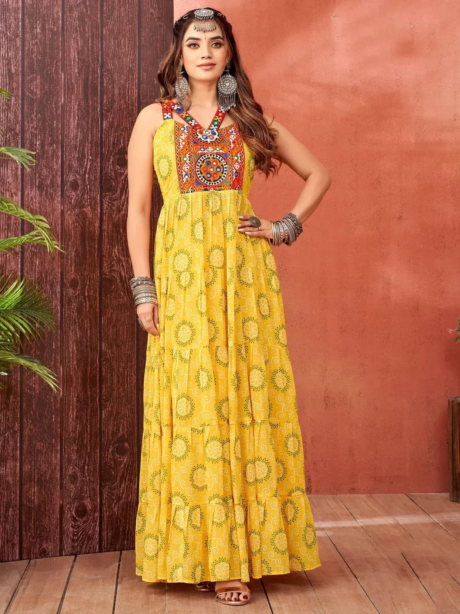 Yellow ethnic gown with mirror work and printed tiered skirt, perfect for Indian occasions