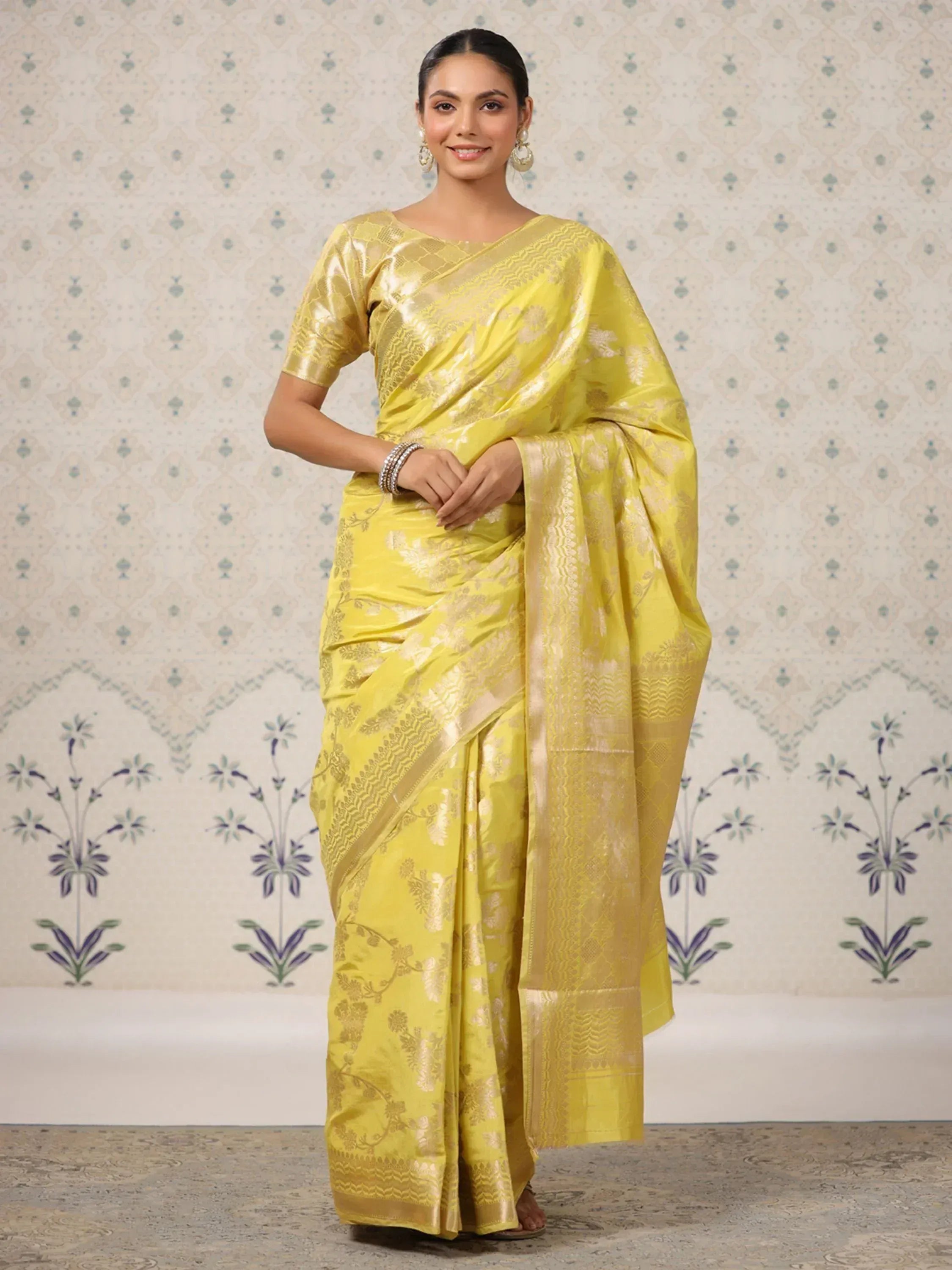 Yellow designer saree with gold floral zari work, perfect for ethnic occasions and festive wear.