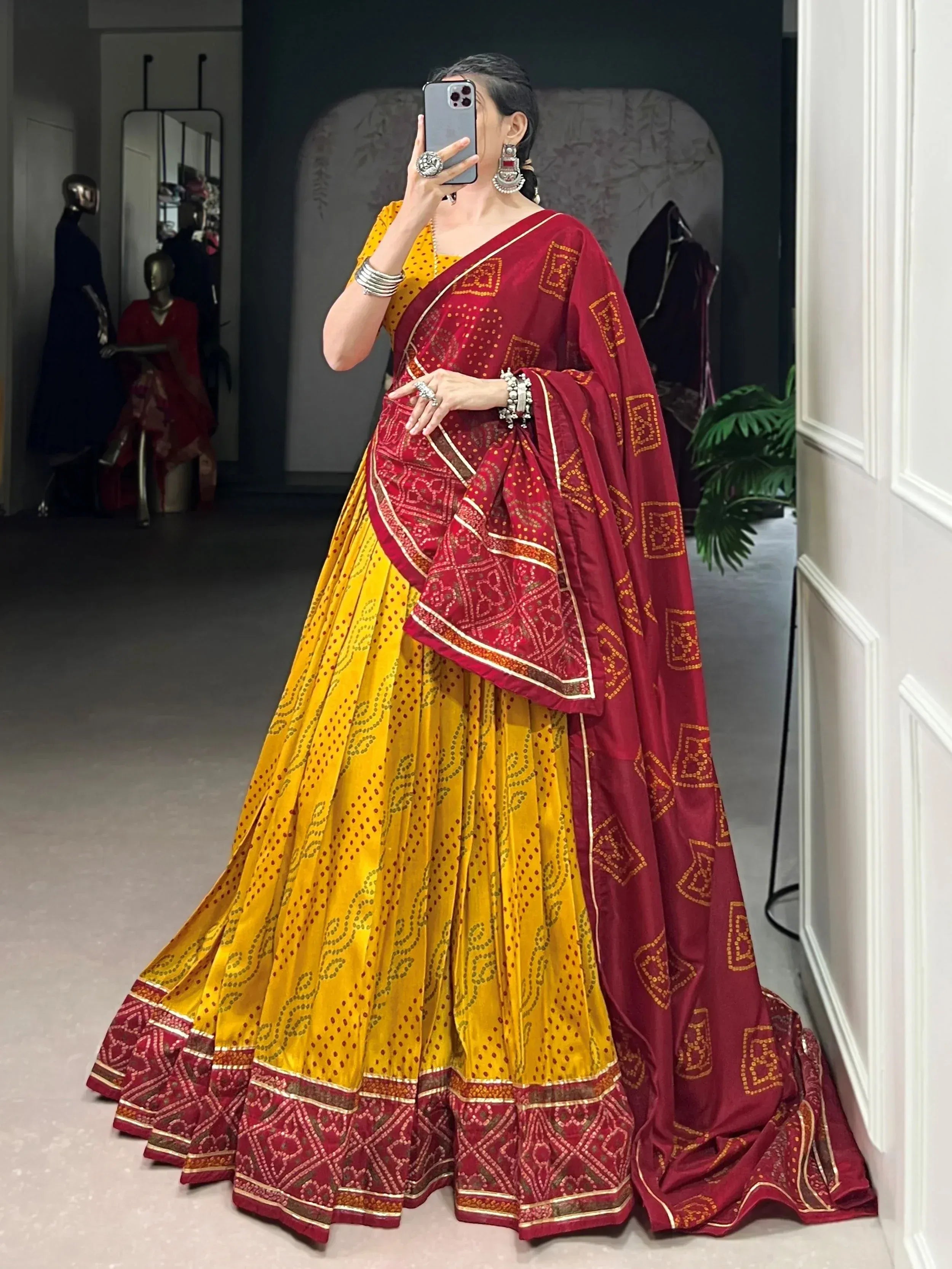 Yellow and maroon ethnic lehenga choli with printed patterns, perfect for Indian weddings and festivals