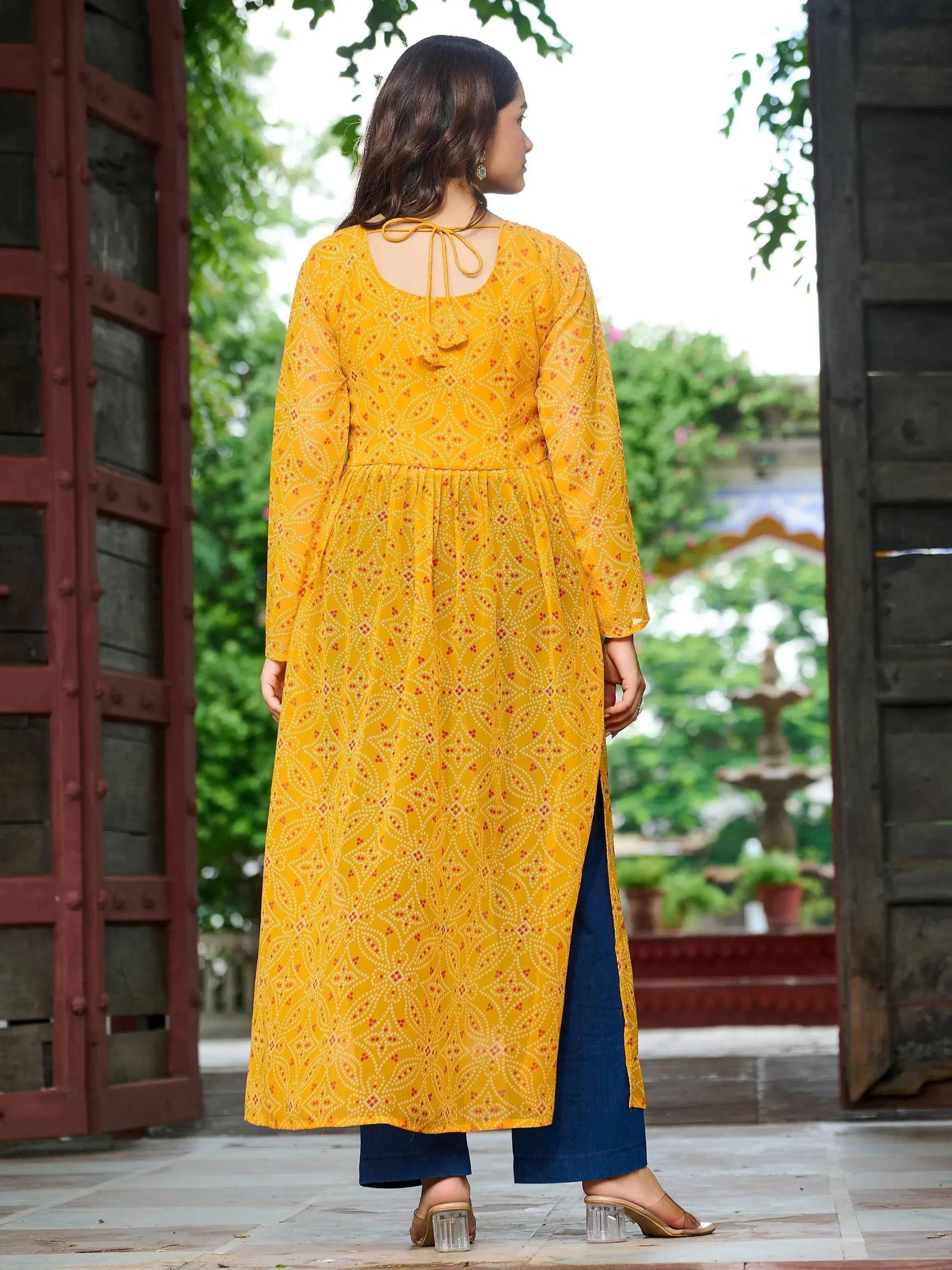 Yellow printed kurta with tie-back detail, paired with blue palazzo pants, perfect for ethnic wear.