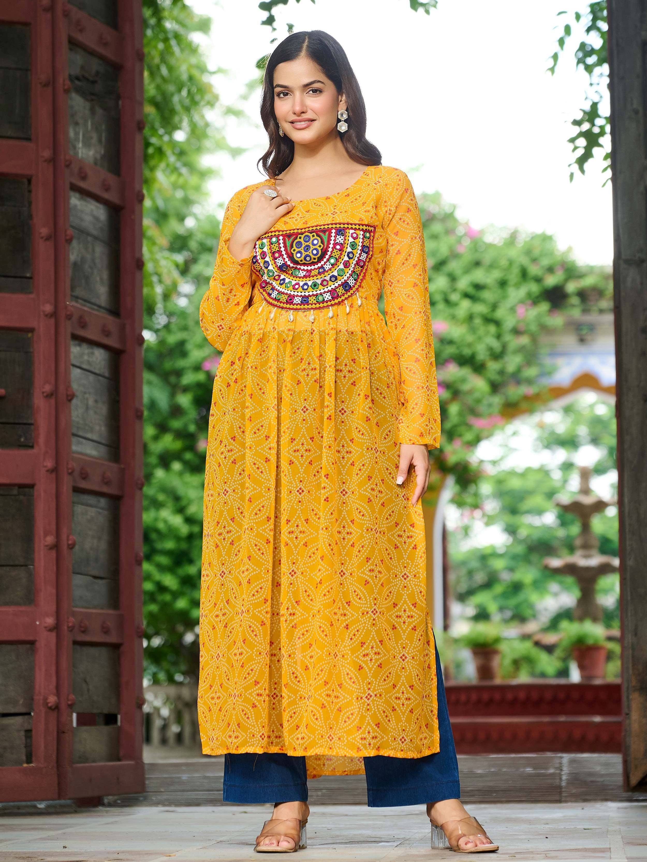 Yellow ethnic kurti with mirror work and printed pattern, paired with blue pants for casual wear