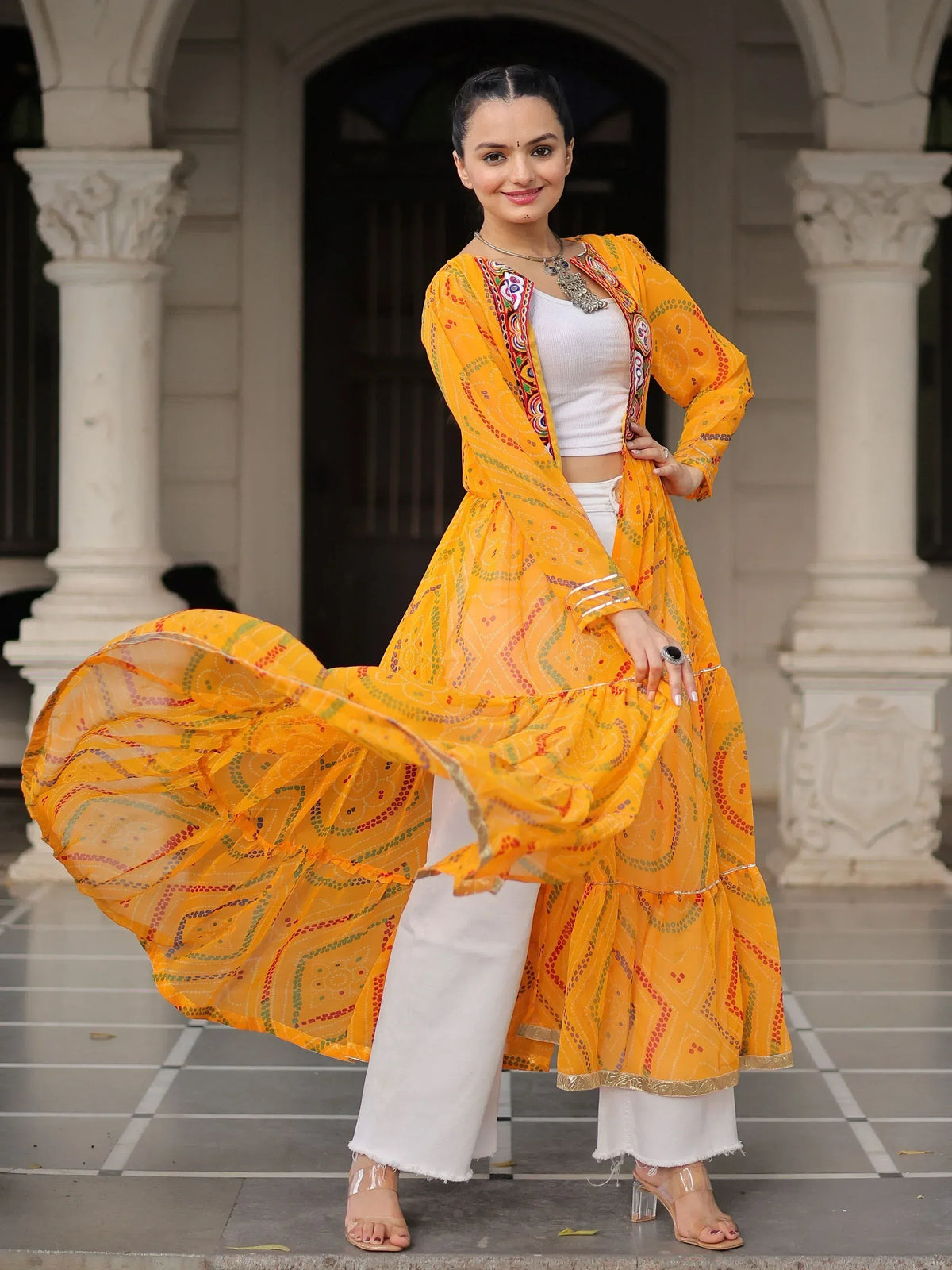 Vibrant yellow printed ethnic gown with white pants, perfect for Indian festive wear