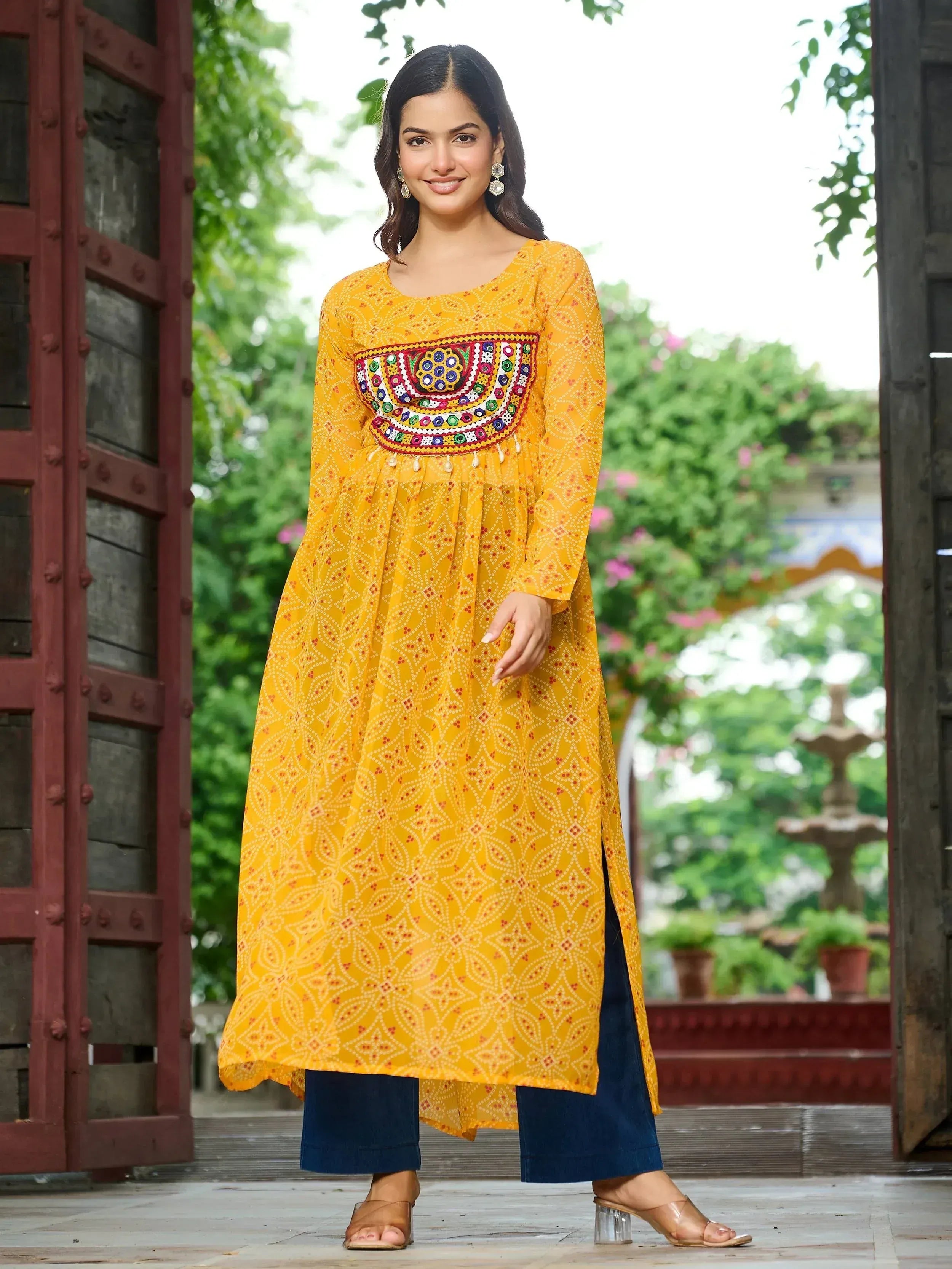 Yellow ethnic kurta with mirror work and printed pattern, paired with blue pants for women
