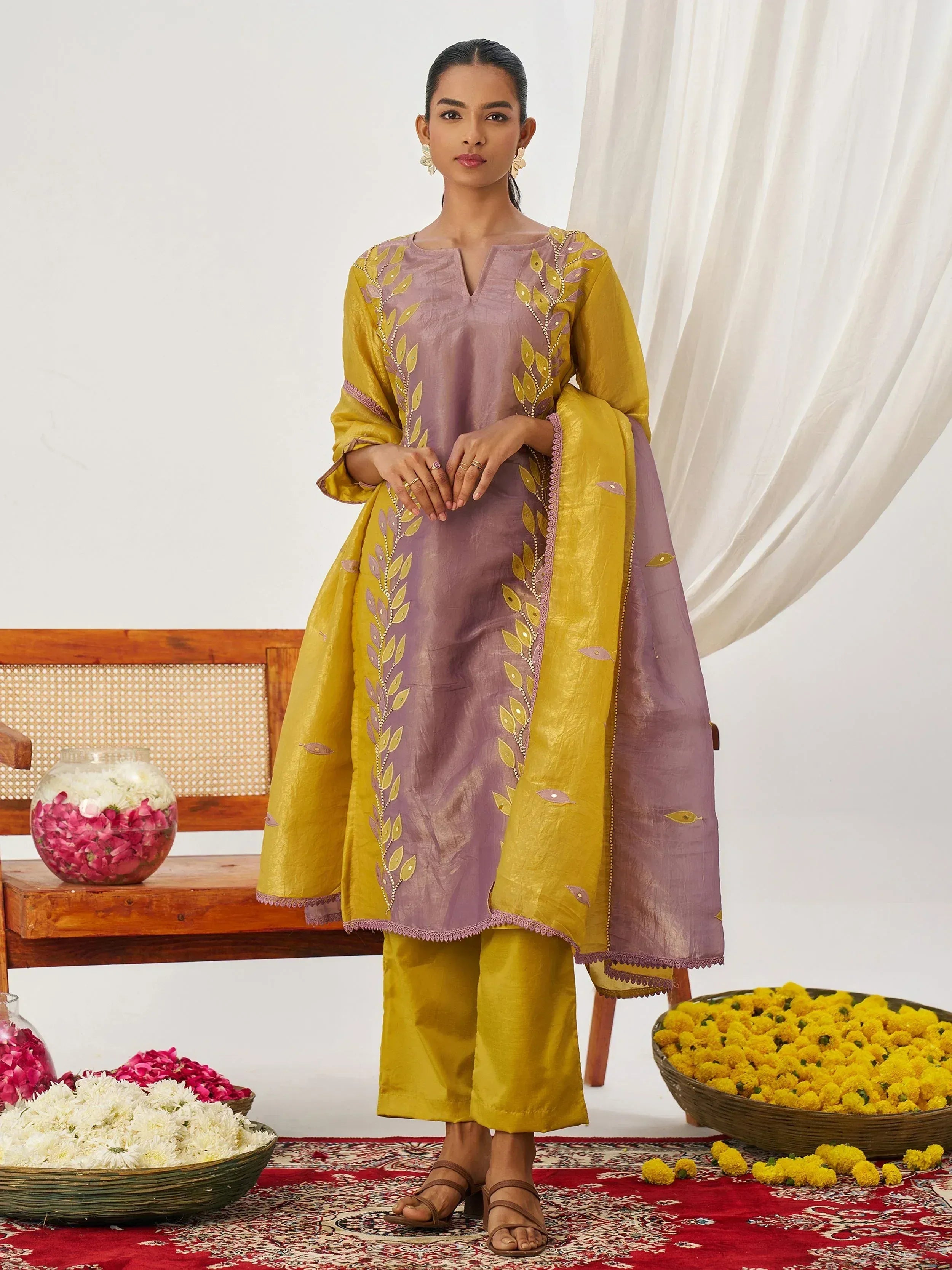 Purple and mustard yellow embroidered salwar kameez with floral motifs, perfect for Indian ethnic wear occasions.