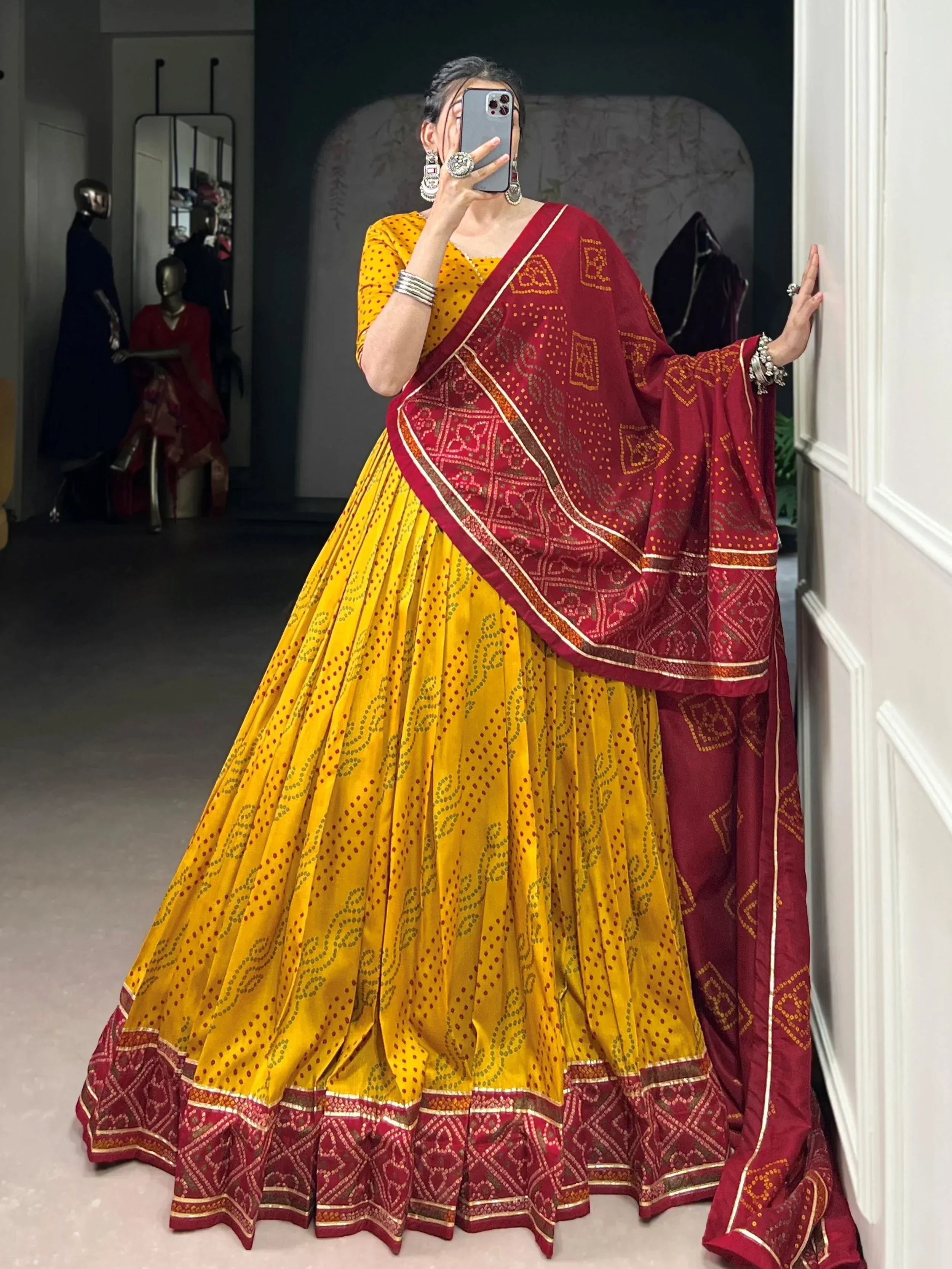 Yellow and maroon printed lehenga choli with ethnic dupatta, perfect for Indian weddings and festive occasions
