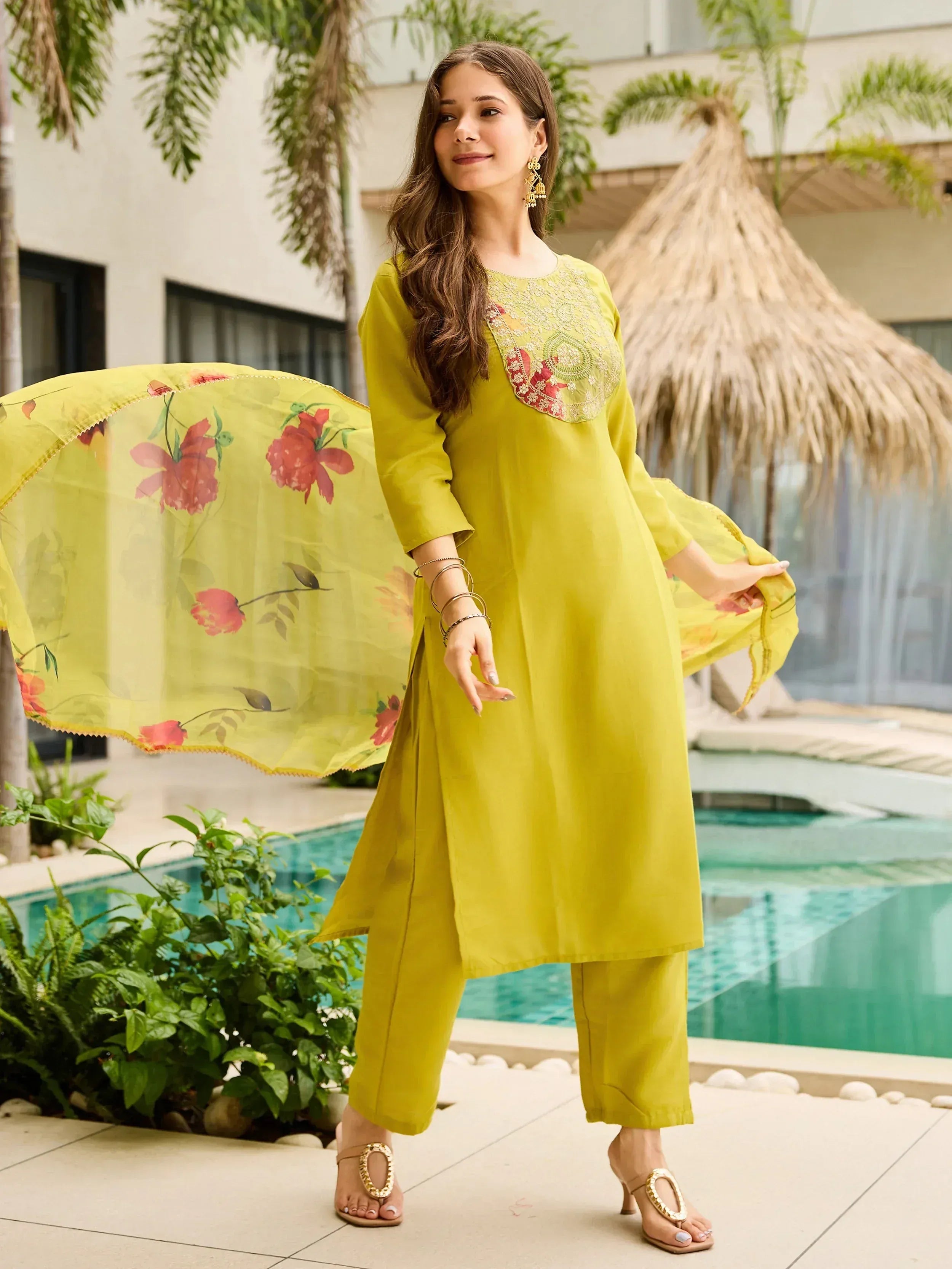 Yellow embroidered kurta set with floral dupatta, perfect for ethnic occasions near poolside