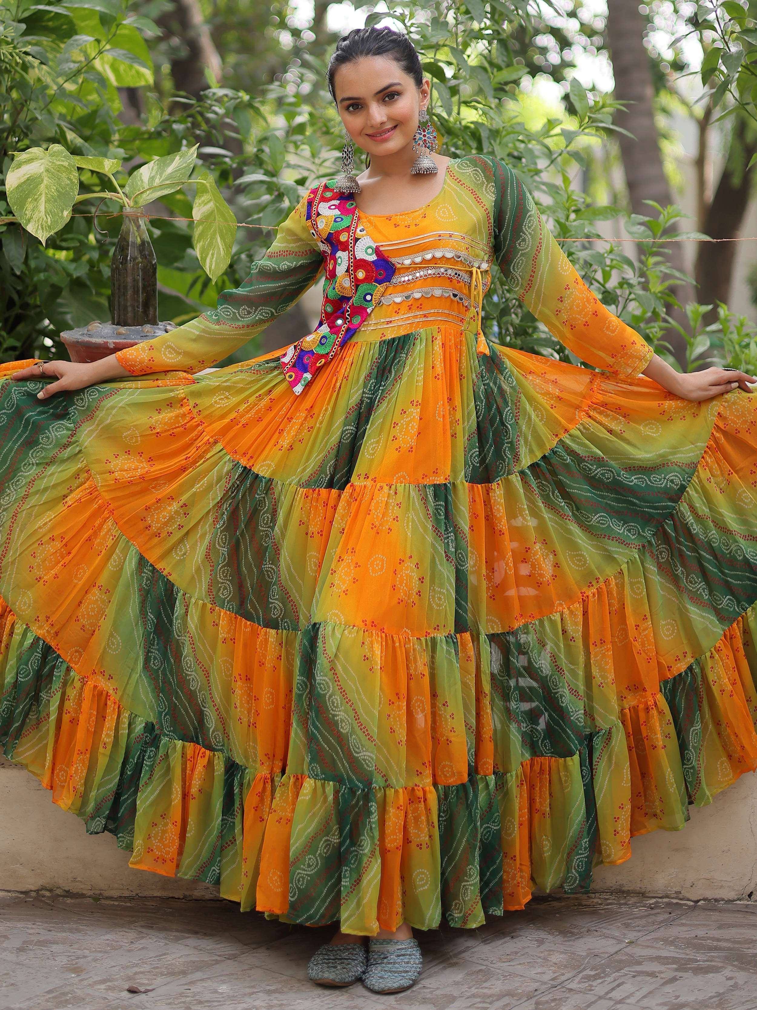 Vibrant orange and green tiered ethnic gown with mirror work, perfect for festive occasions