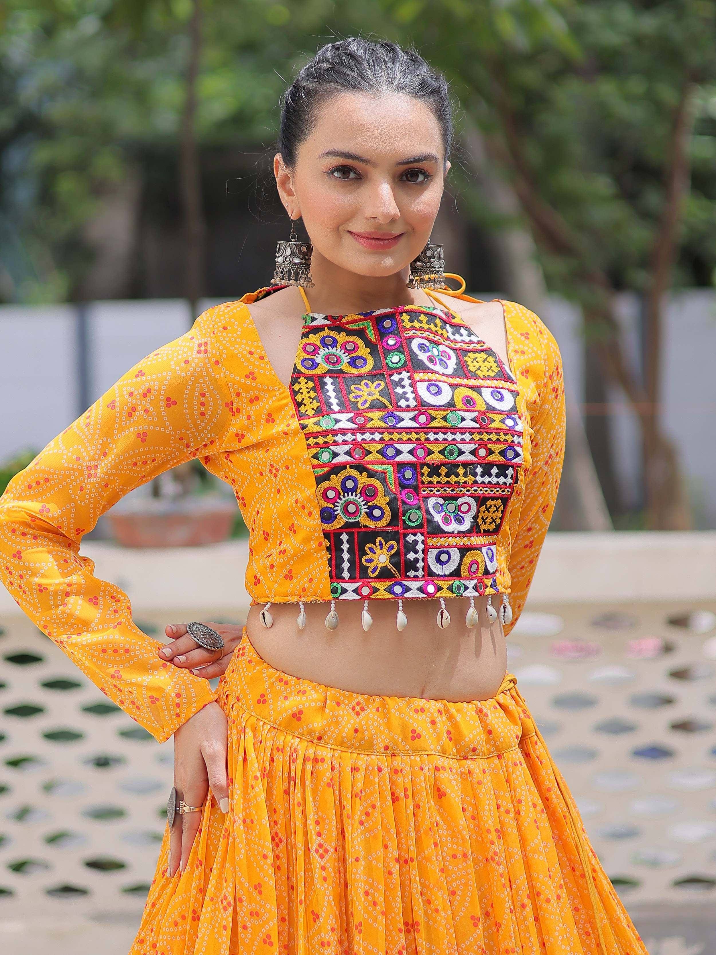 Vibrant yellow ethnic lehenga choli with colorful embroidery and shell detailing, perfect for festive occasions.