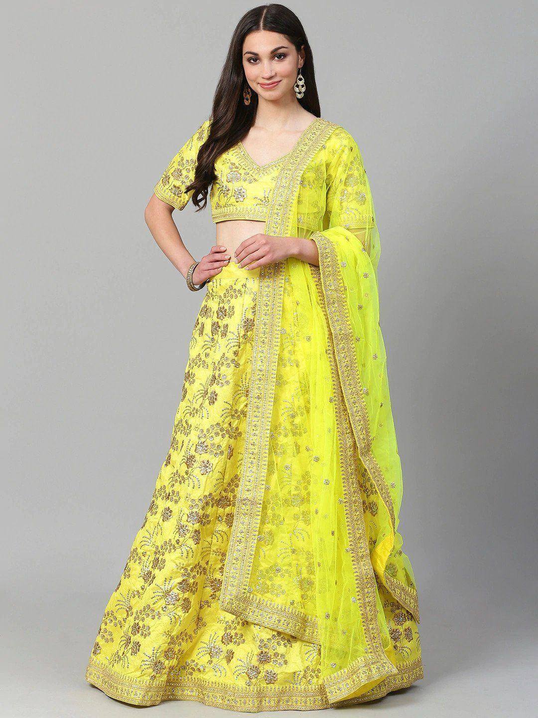 Yellow embroidered lehenga choli with gold floral work and sheer dupatta, perfect for Indian ethnic occasions