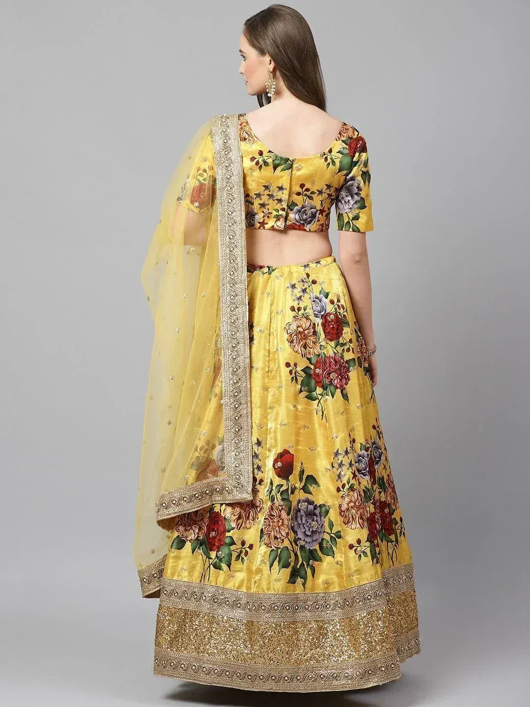 Yellow floral lehenga choli with gold border and sheer dupatta, ethnic Indian wear