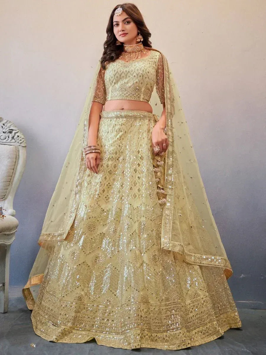 Elegant gold embroidered lehenga choli with sheer dupatta, perfect for Indian weddings and festive occasions.