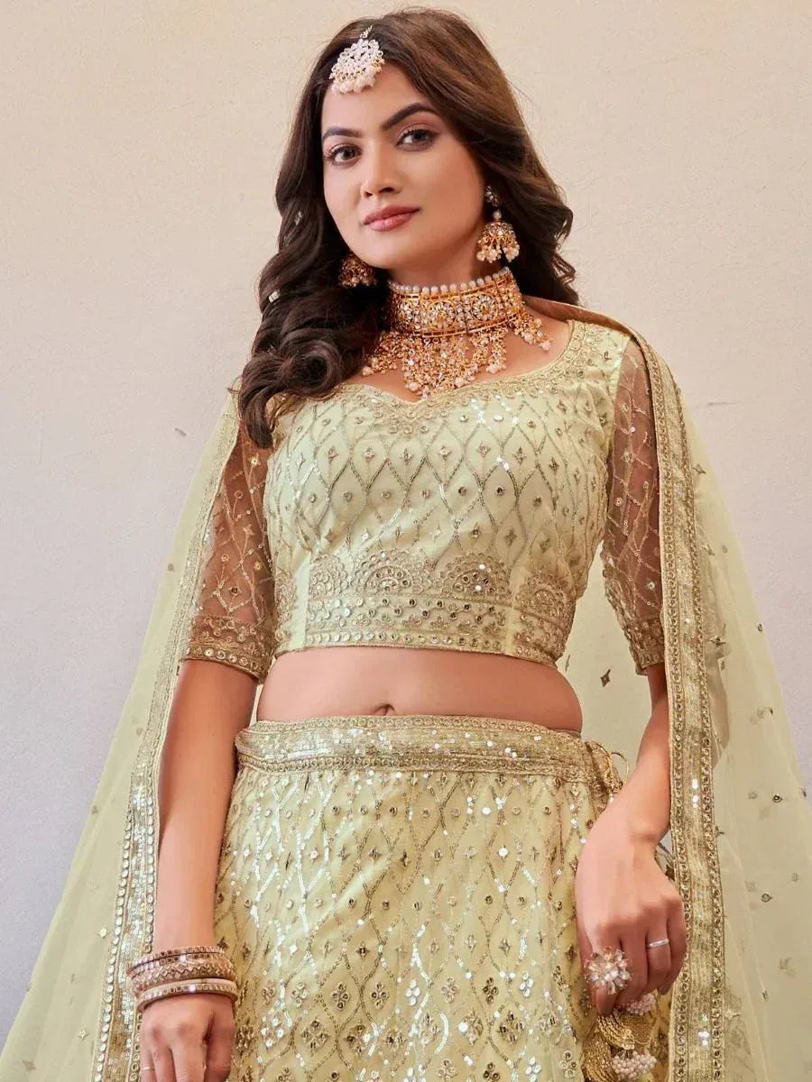 Elegant light green lehenga choli with gold embroidery, perfect for Indian weddings and festive occasions.