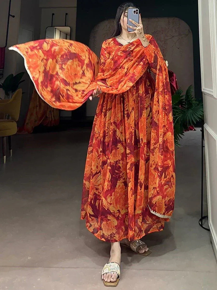 Vibrant orange floral print ethnic gown with flowing sleeves, perfect for Indian occasions