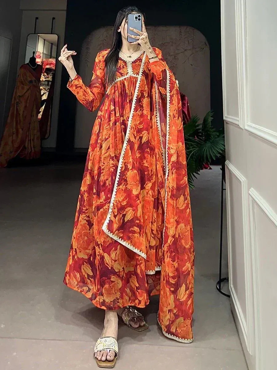 Orange floral print ethnic gown with white trim, styled for festive occasions