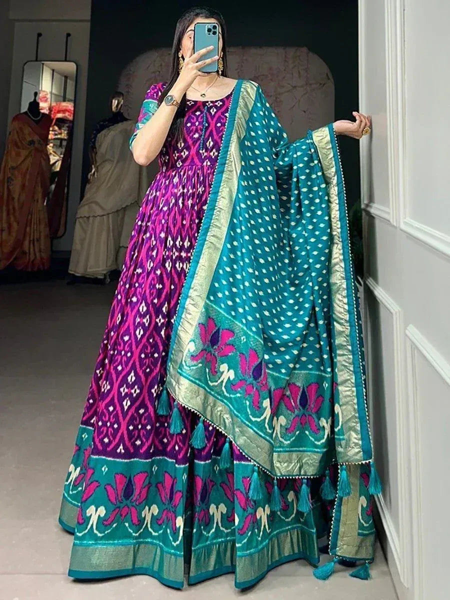 Vibrant purple and teal ikat print lehenga choli with floral dupatta, perfect for Indian ethnic occasions