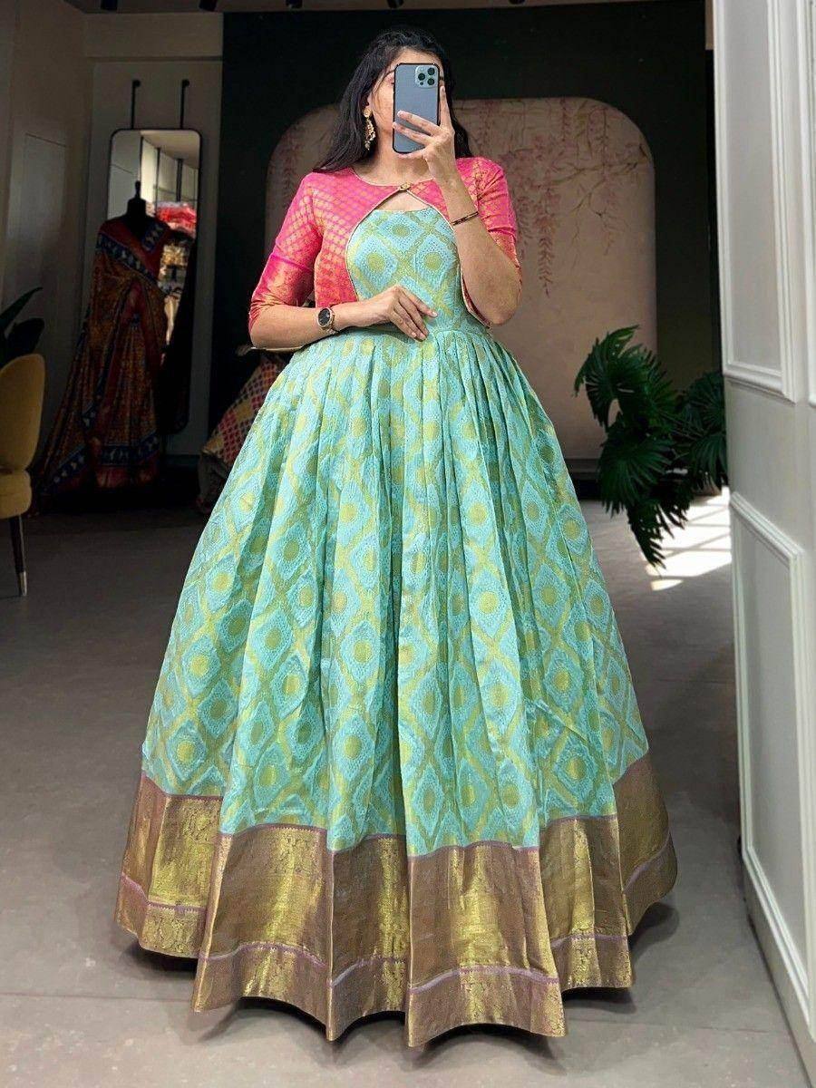 Woman in mint green printed lehenga with pink blouse, ethnic Indian wear for festive occasions