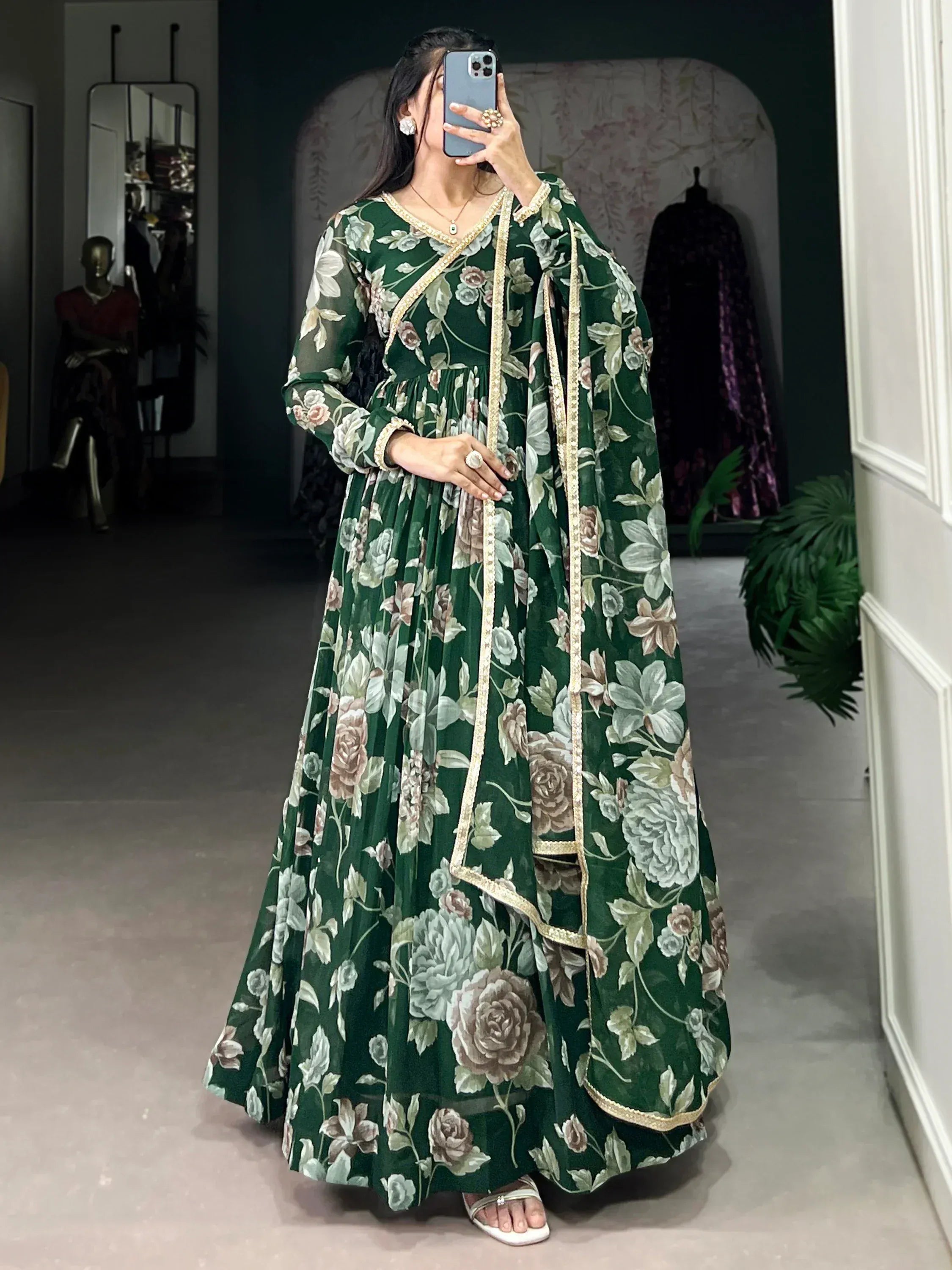 Woman wearing green floral ethnic gown with gold trim and matching dupatta