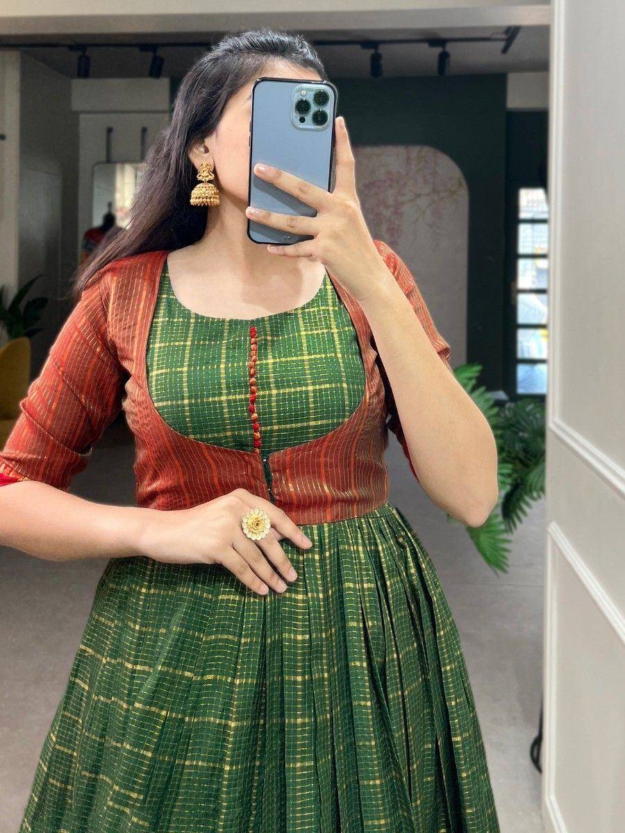Green and gold checkered ethnic gown with orange striped jacket, perfect for Indian occasions