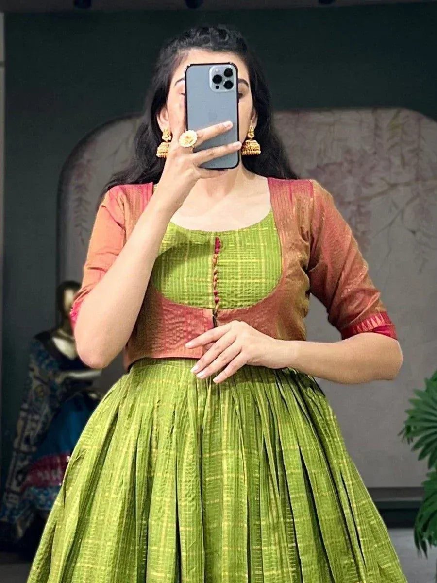 Green and rust ethnic lehenga choli with pleated skirt, perfect for Indian weddings or festive occasions