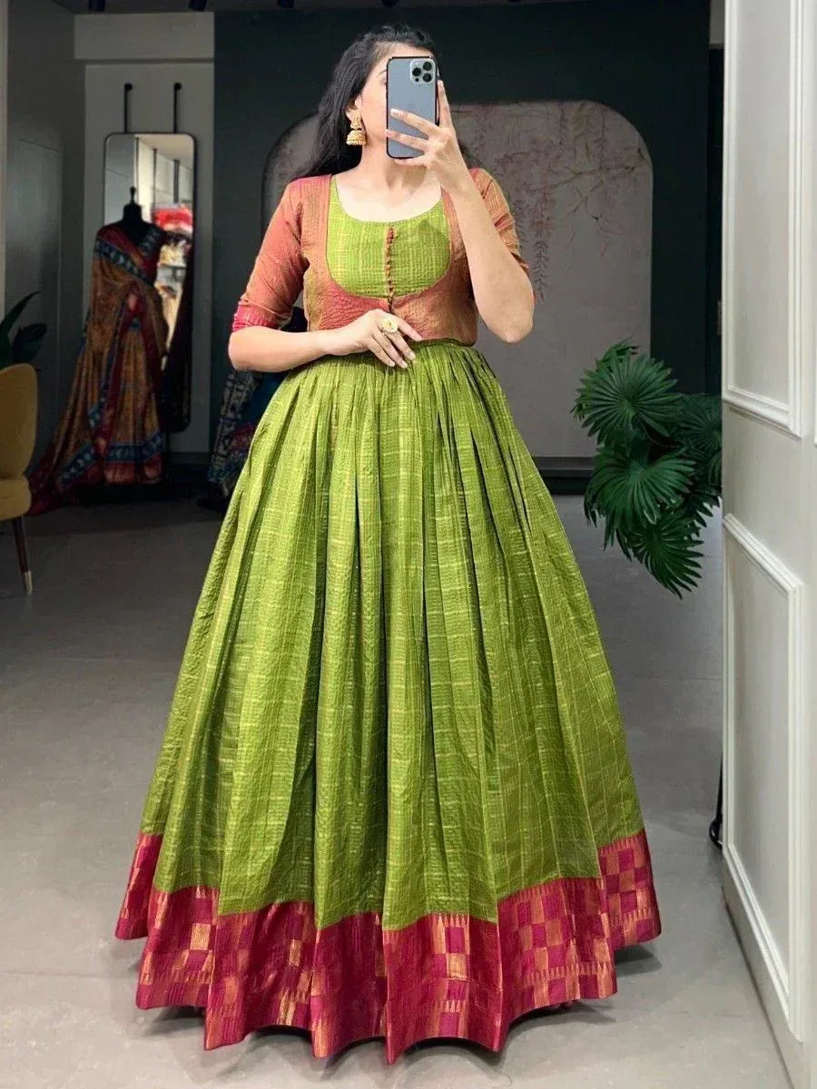 Green and red ethnic lehenga choli with pleated skirt, perfect for Indian festive occasions