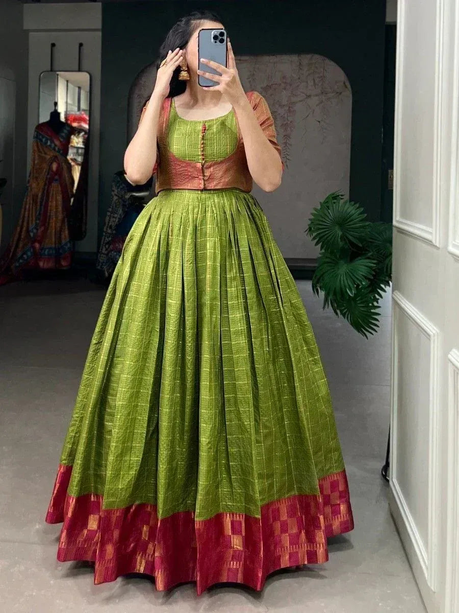 Green and red ethnic lehenga choli with pleated skirt, perfect for Indian weddings and festive occasions