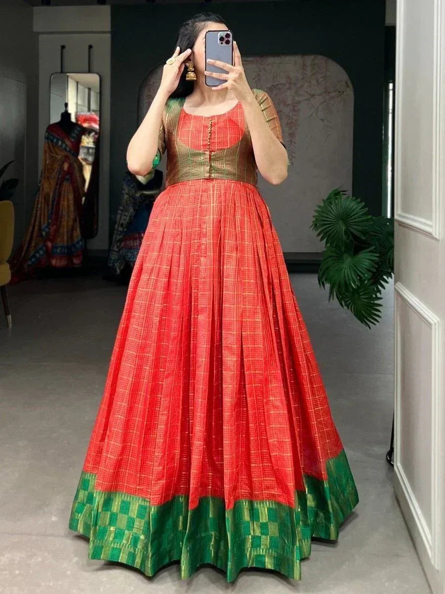 Red and green ethnic lehenga choli with pleated skirt and checkered border, perfect for Indian celebrations