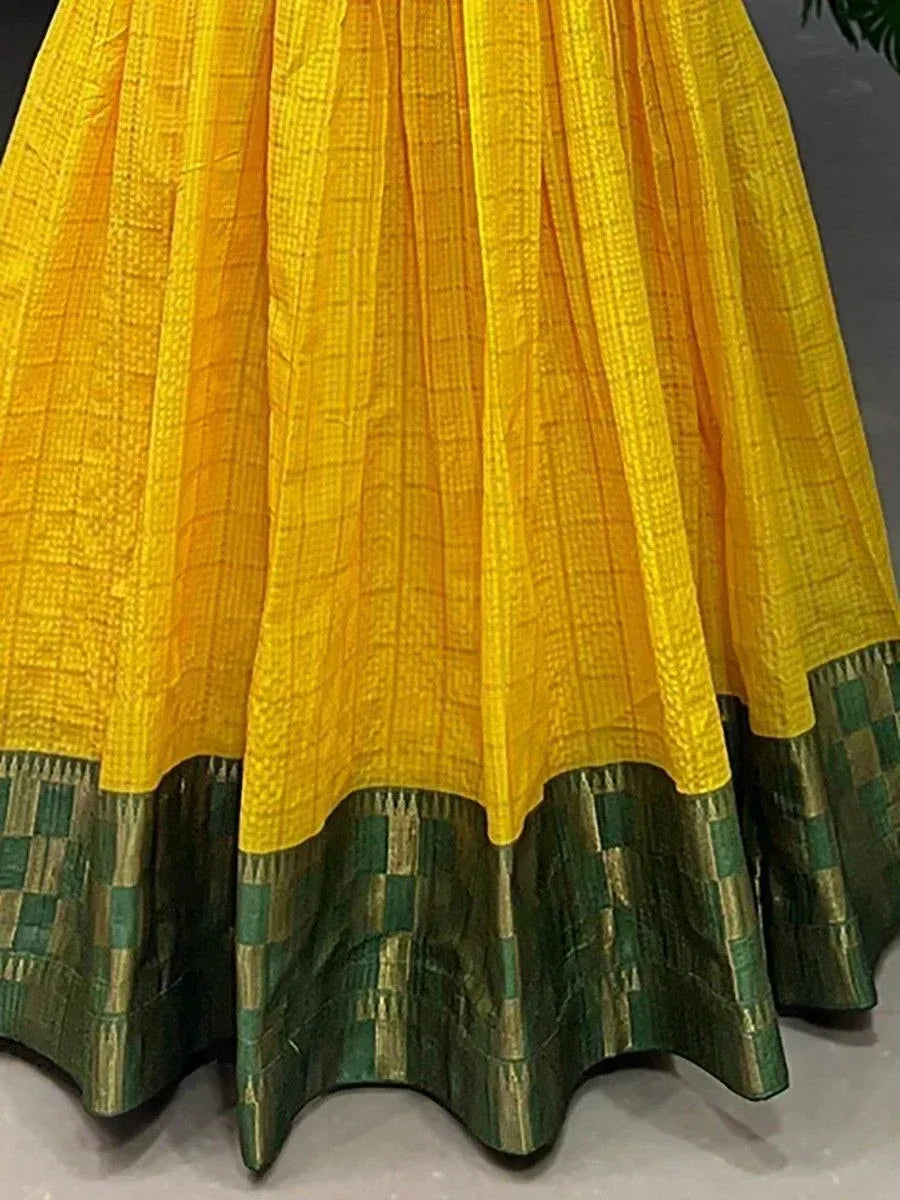 Yellow and green ethnic lehenga skirt with checkered pattern and woven border detail