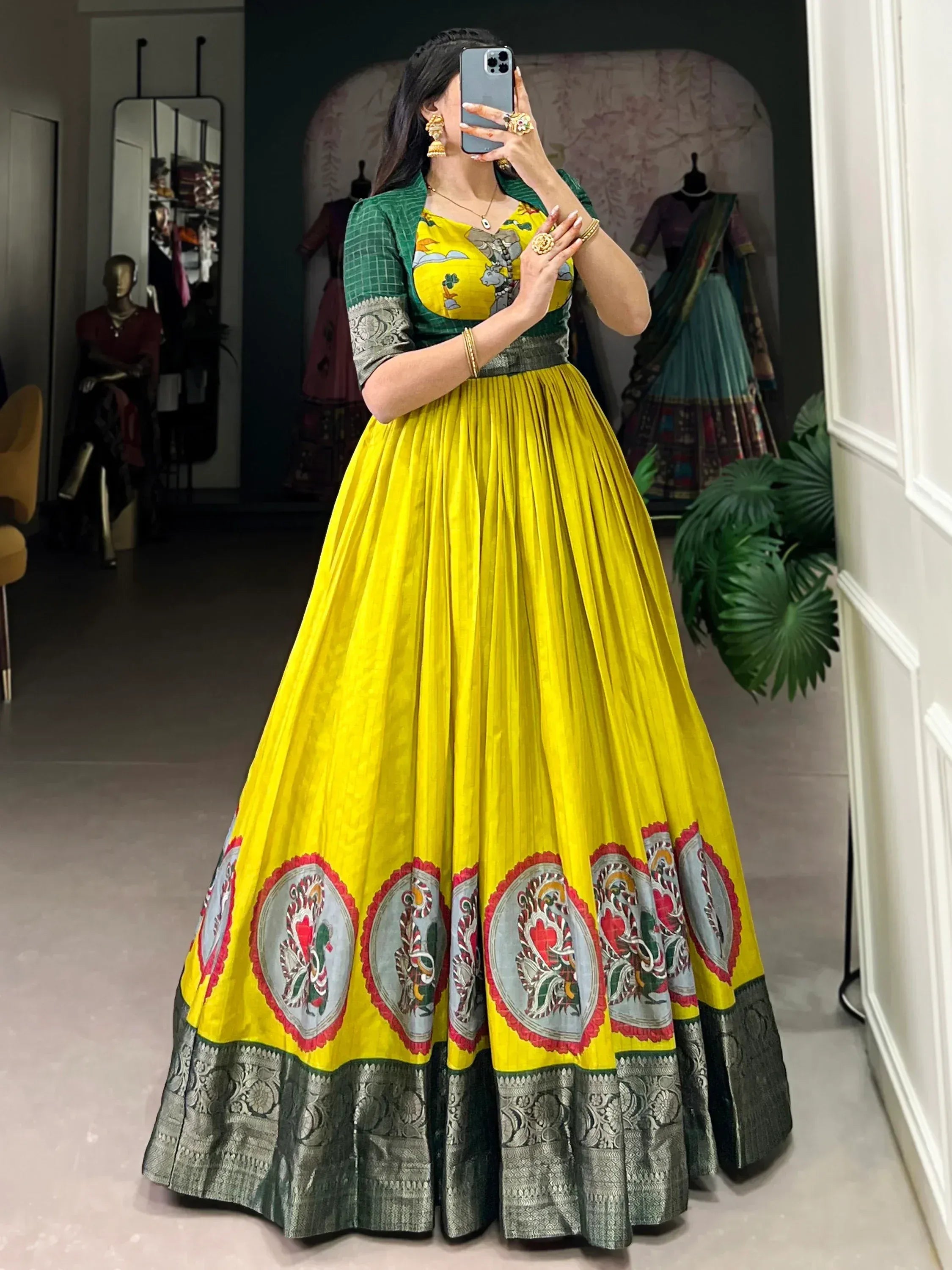 Vibrant yellow lehenga choli with green blouse, floral border, and traditional Indian ethnic wear design