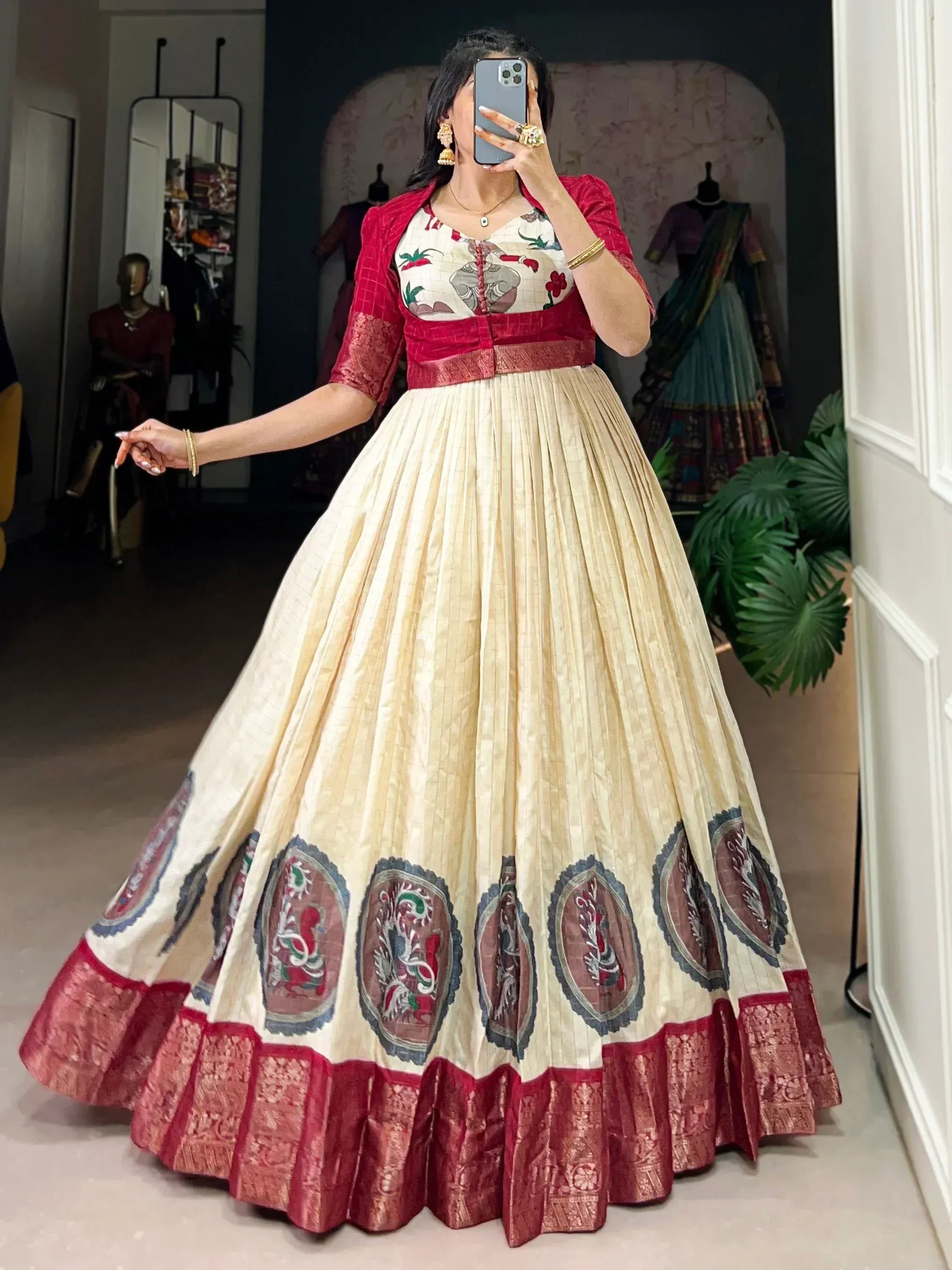 Elegant cream and red ethnic lehenga with intricate embroidery and pleated skirt design