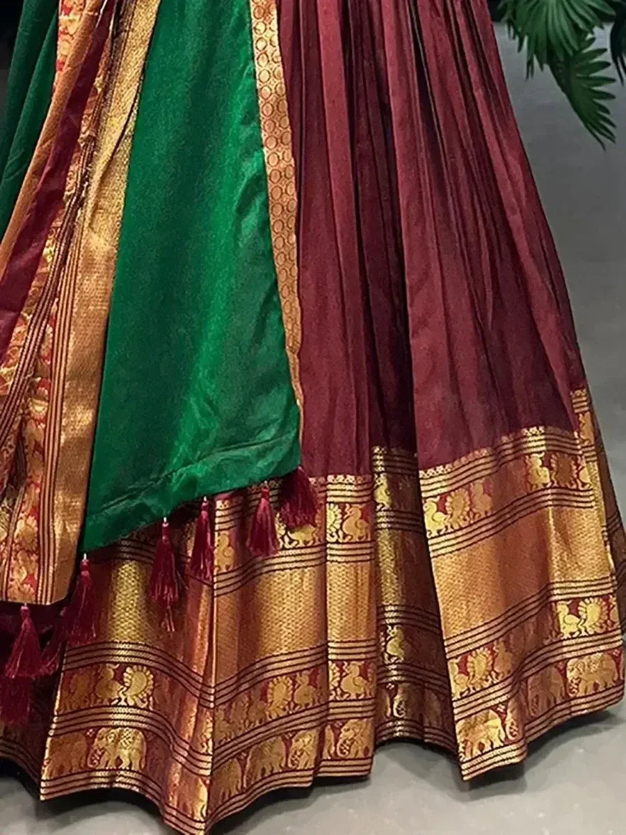 Rich maroon and green silk lehenga with gold elephant border and tassels, traditional Indian ethnic wear