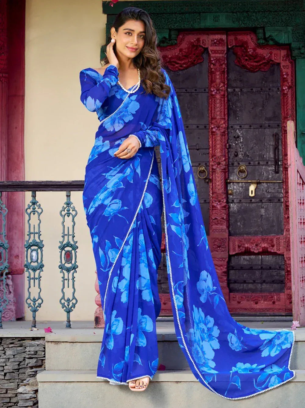 Blue floral saree with pearl border, styled for ethnic wear occasions