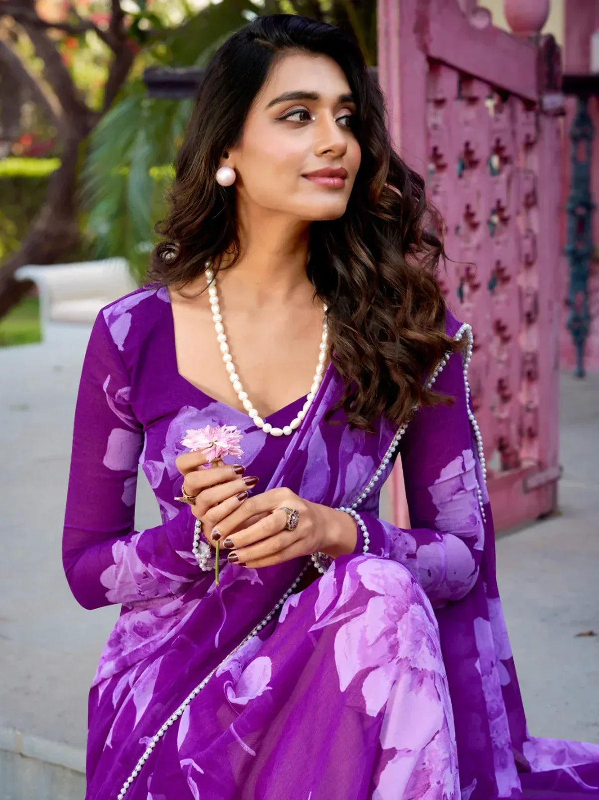 Purple floral saree with pearl accessories, elegant Indian ethnic wear