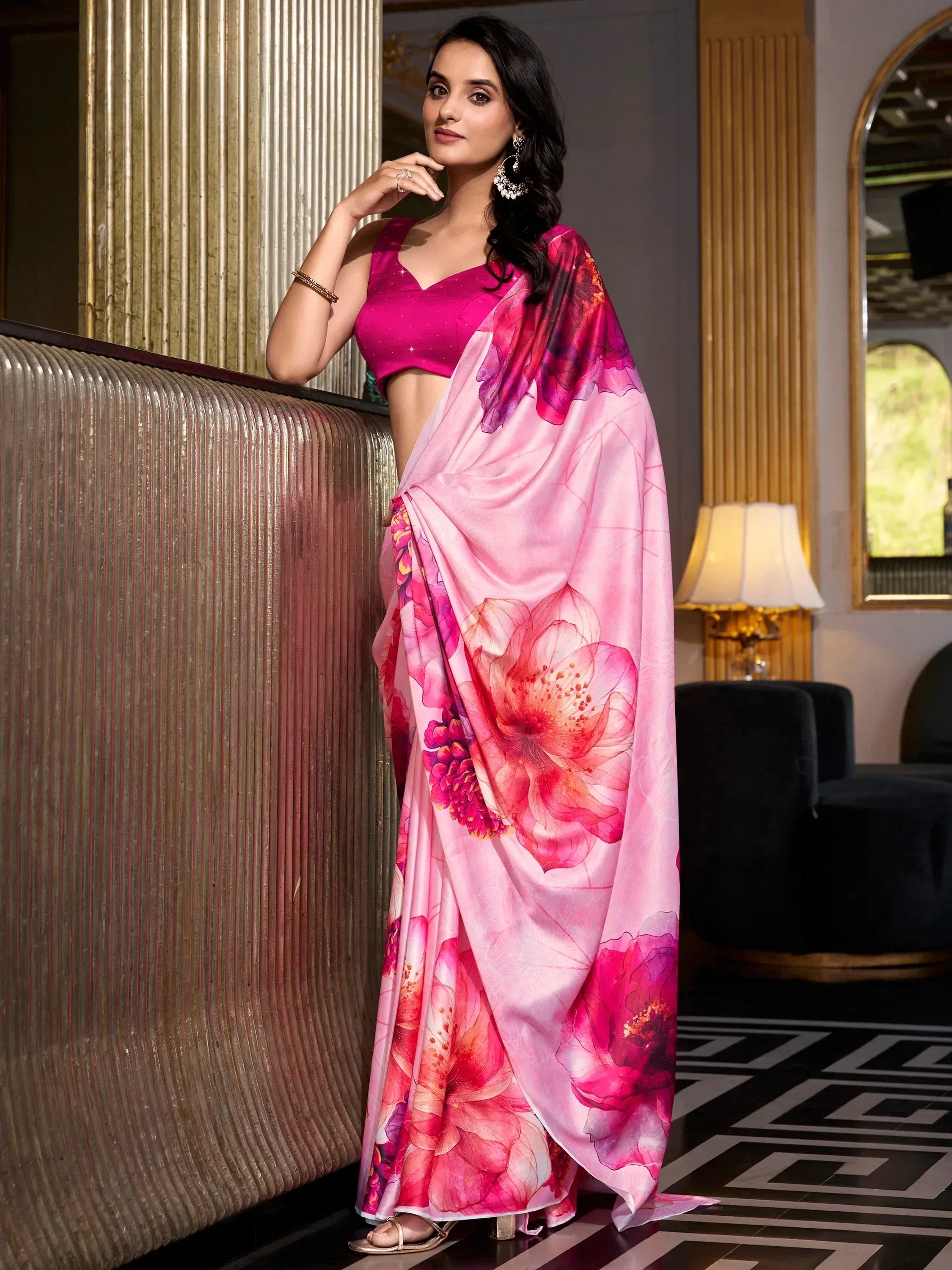 Woman in pink floral saree with matching blouse, elegant Indian ethnic wear for festive occasions