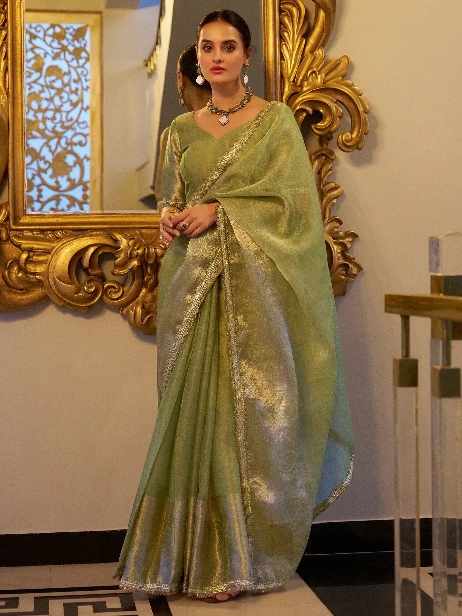 Elegant green saree with gold border, styled with matching jewelry for Indian ethnic wear